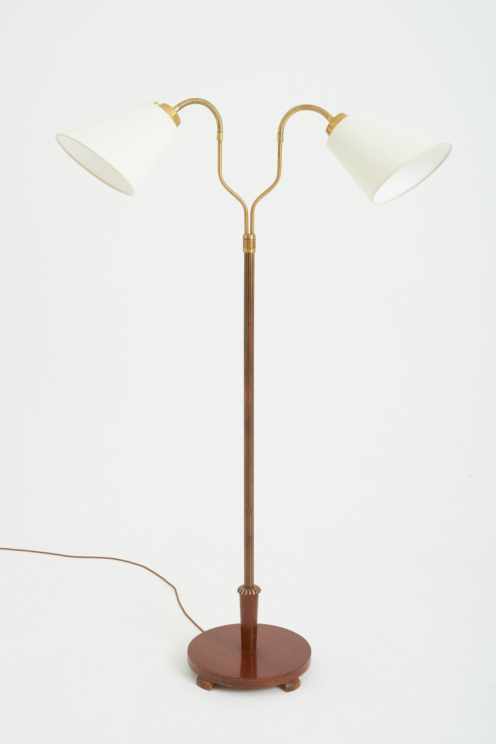 A two-armed brass and mahogany floor lamp
Sweden, Circa 1950
148 cm high by 79 cm wide by 41 cm depth