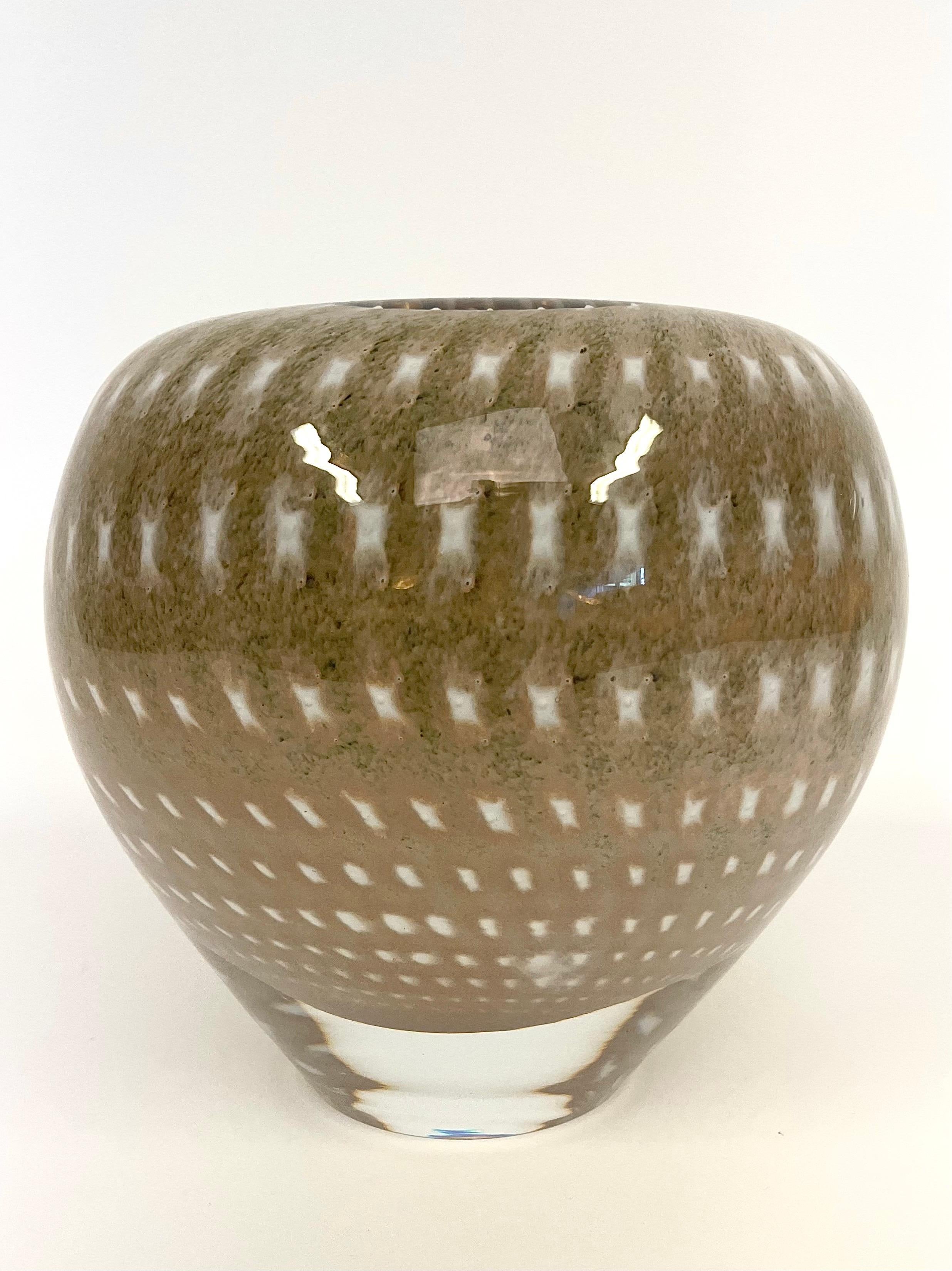 This is the Swedish very rare glass vase in the Kosta Boda series Artist Collection, designed by the glass artist Monica Backström.
It comes with a folded, smooth rounded edge and handmade with overlay technique.  The vase is a very heavy and steady