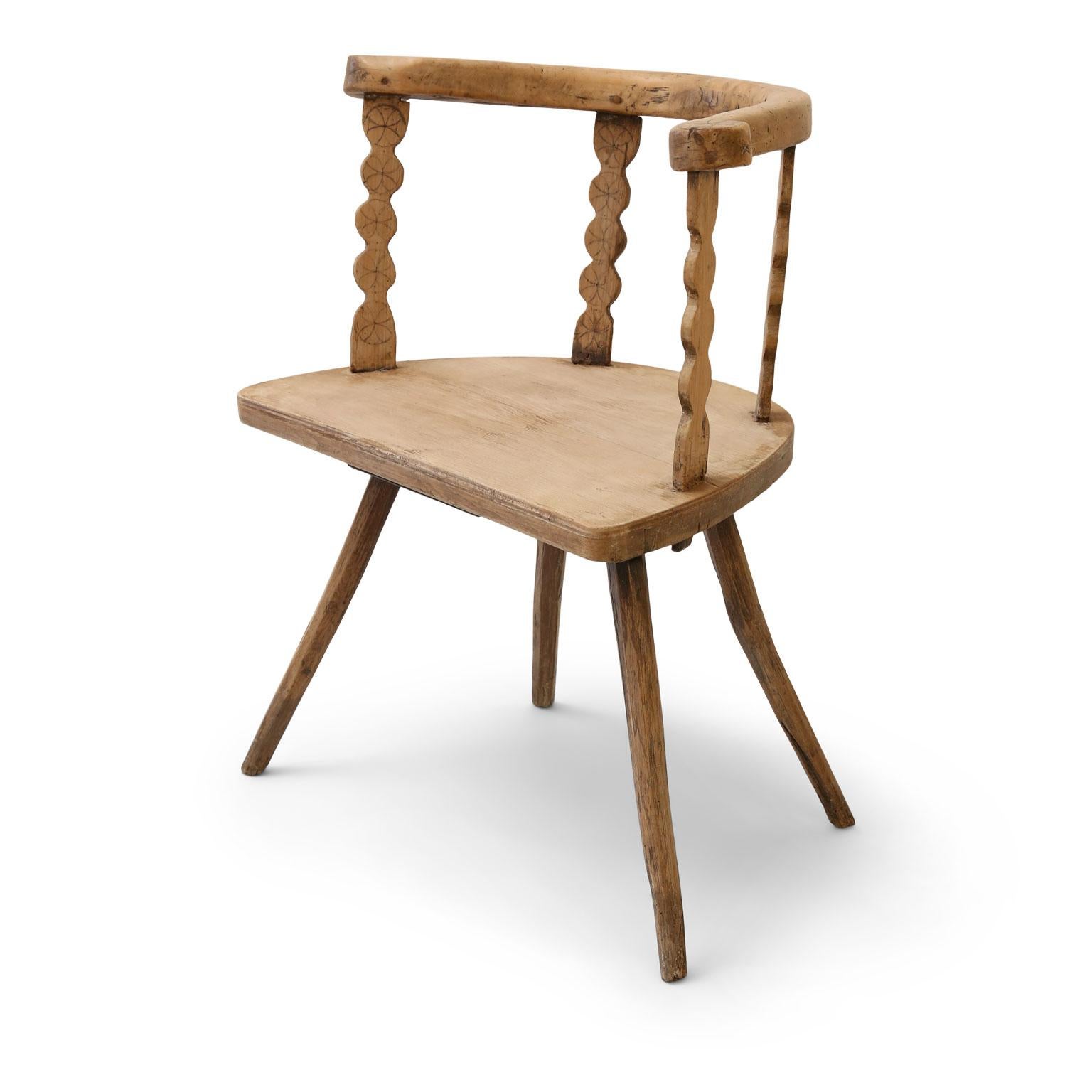 Swedish vernacular chair dating to the early 19th or late 18th century. Nice wide plank seat measuring 17 inches high x 25 inches wide x 16 inches deep. Generous proportioned horse shoe shape back and arms upon shaped slats. Decorated in incised
