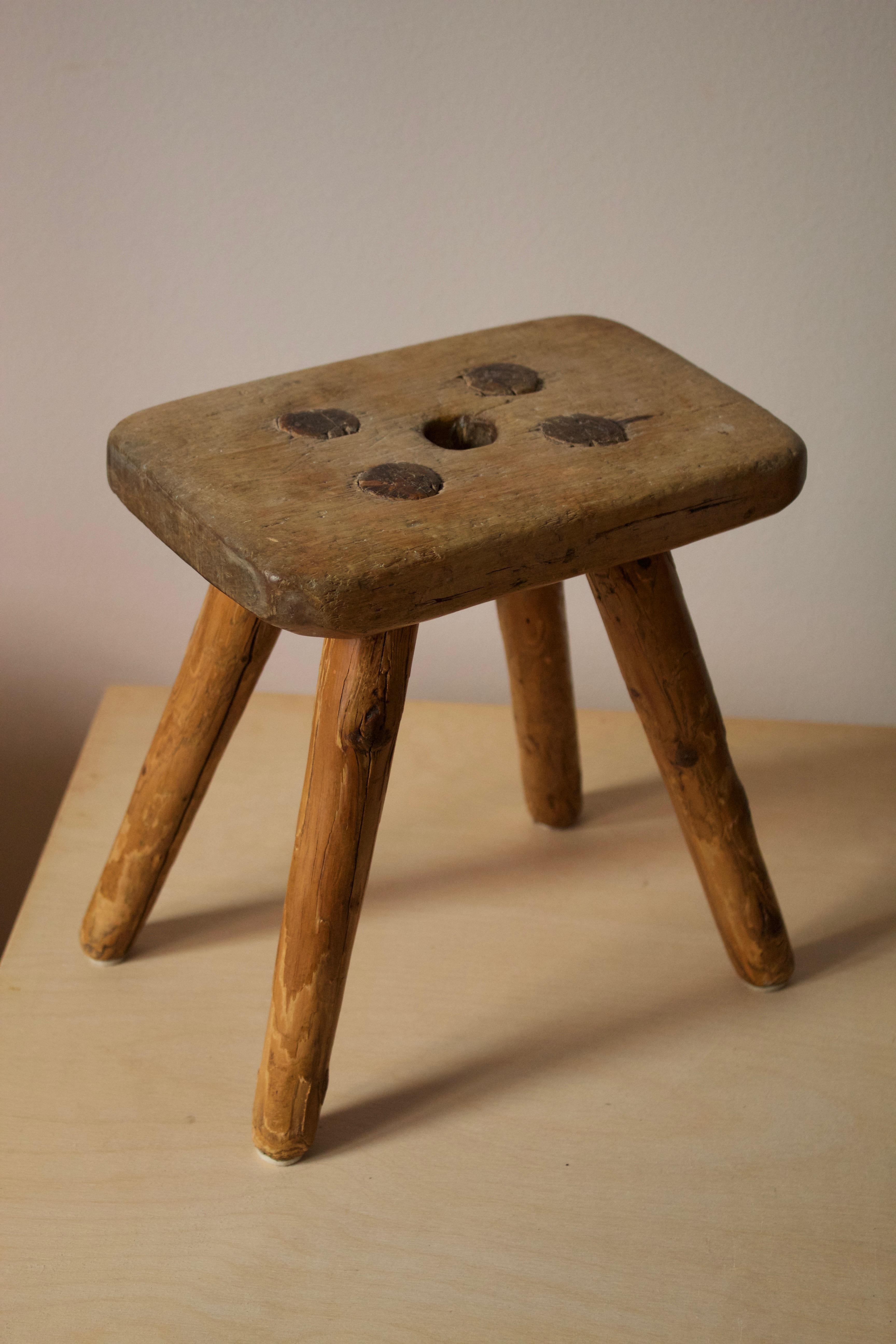A very small milking stool, Swedish folk craft, c. 1900. Features revealed joinery.