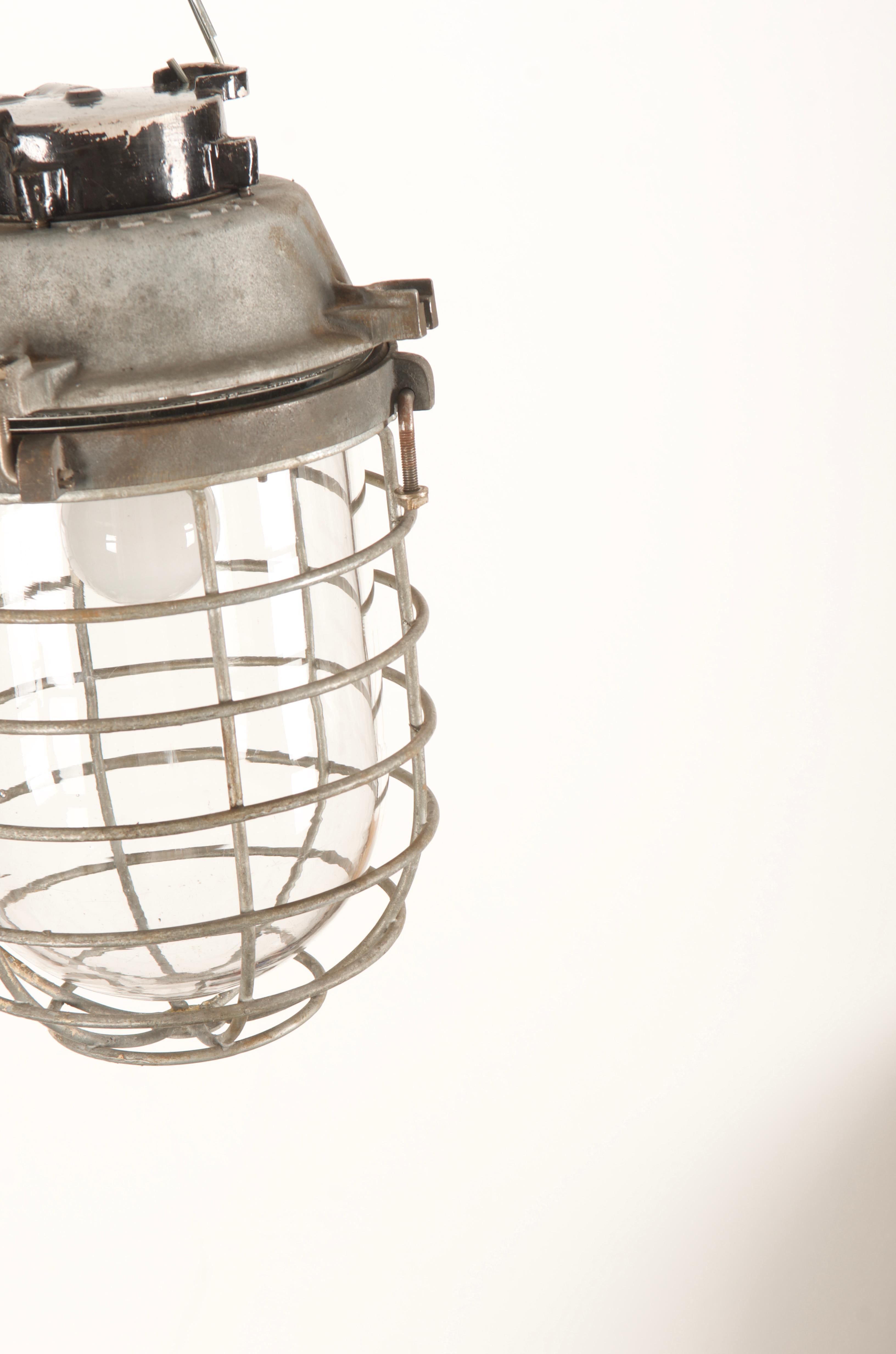 Cast iron, heavy glass with steel mesh, one E27 socket from the 1970s.
Up to 3 pieces available.
