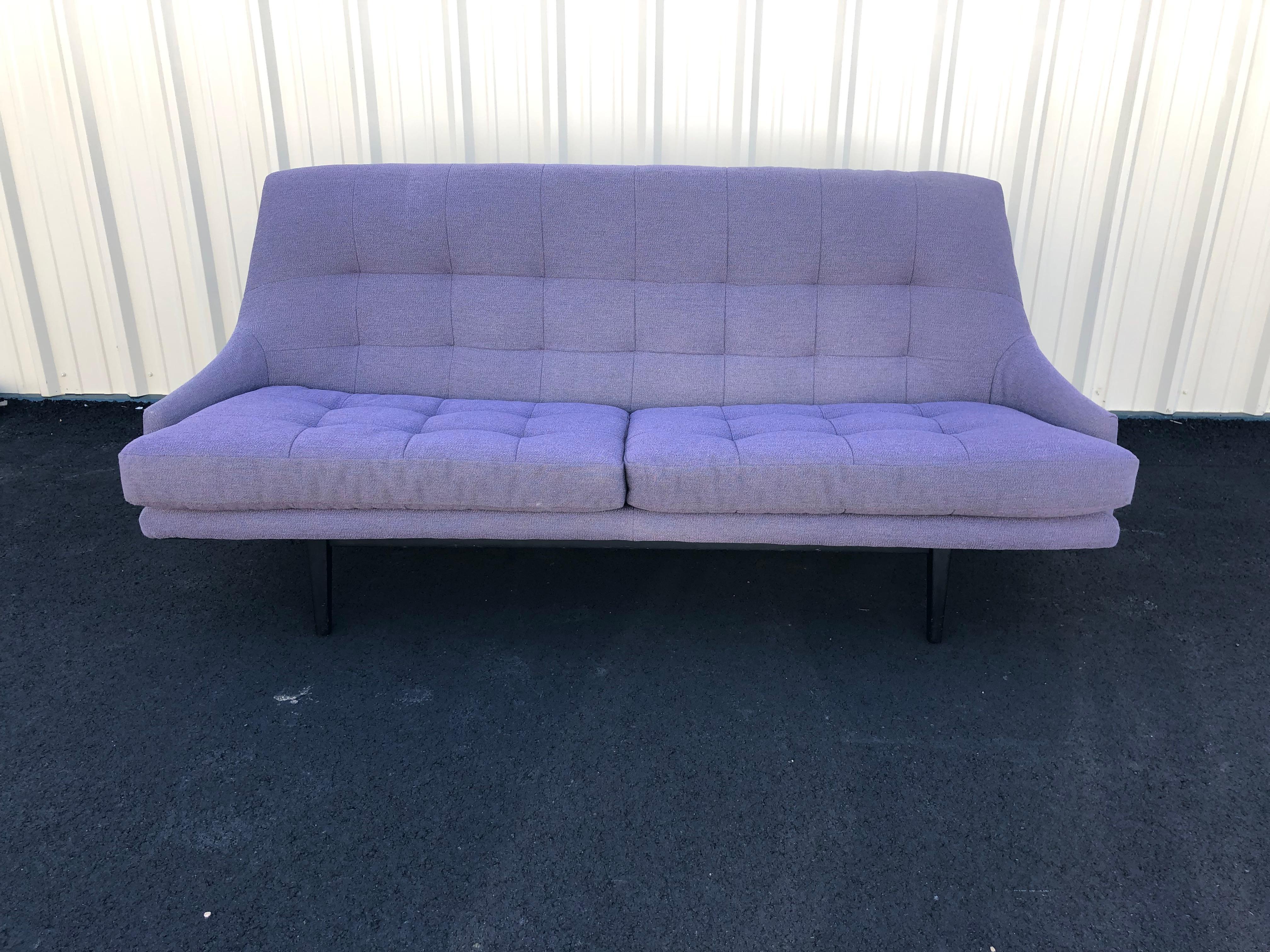 A rare find in this super stylish and very comfortable mid century modern Swedish sofa.  The silhouette is sleek with high back, low arms, double tufted seat cushions and tufted seat back.  Finished on the back so looks great floating in a room. 