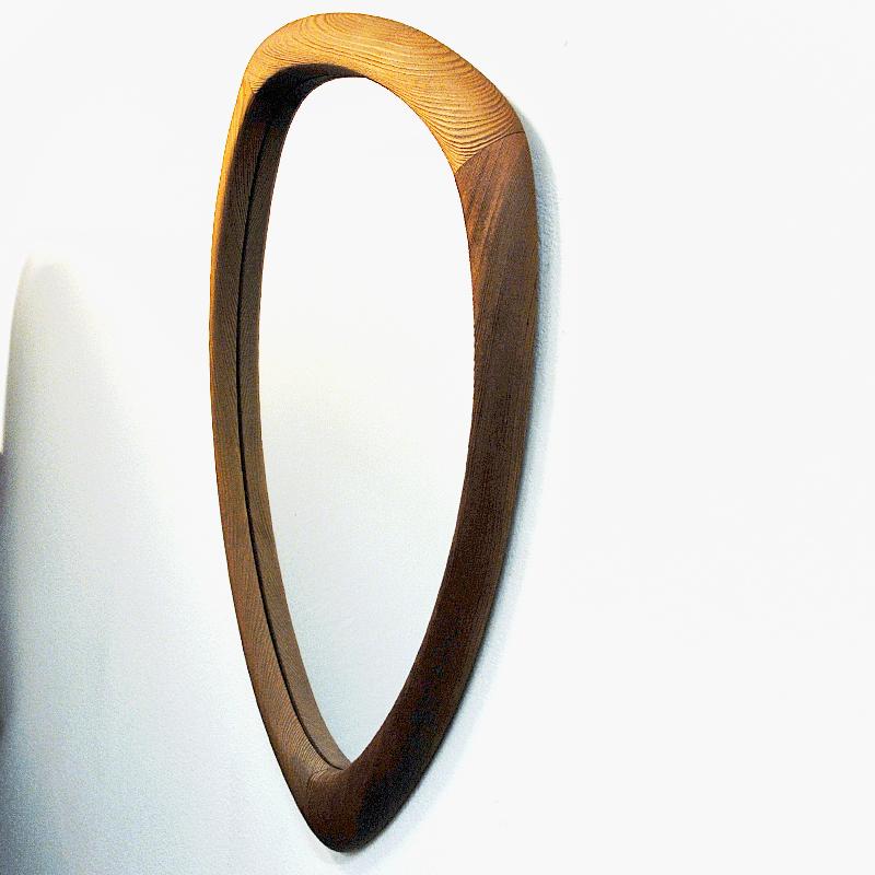 Lovely pine wall mirror from Sweden 1950s. A perfect shaped mirror with an oval drop design. The mirror has beautiful details, such as the visible connected ends and rounded smooth edges. 
Measure: 75 cm H x 42 cm W x 3.5cm D. Great vintage