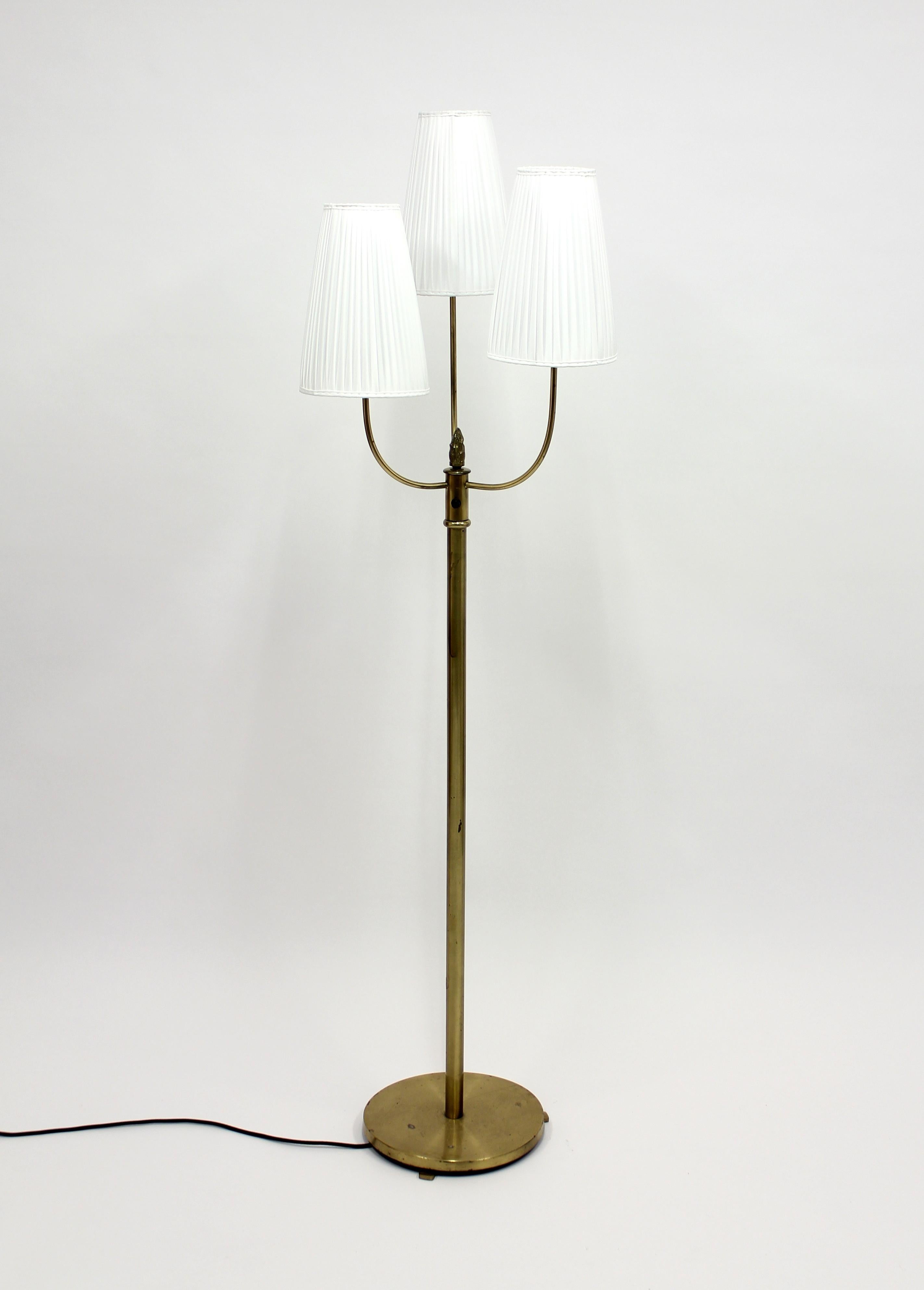 1940s brass three-light floor lamp with pleated shades set at alternating heights. Most likely made in Sweden. This is a very good example of the so called 
