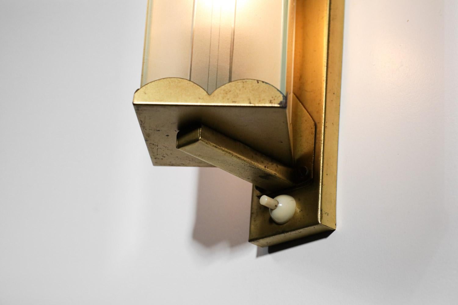 Scandinavian wall lamp from the 50s. Solid brass structure and white frosted glass shade. Very nice vintage condition with a nice patina of time on the whole sconce, electrical system redone, recommended LED bulb type E14. Note a small chip (see