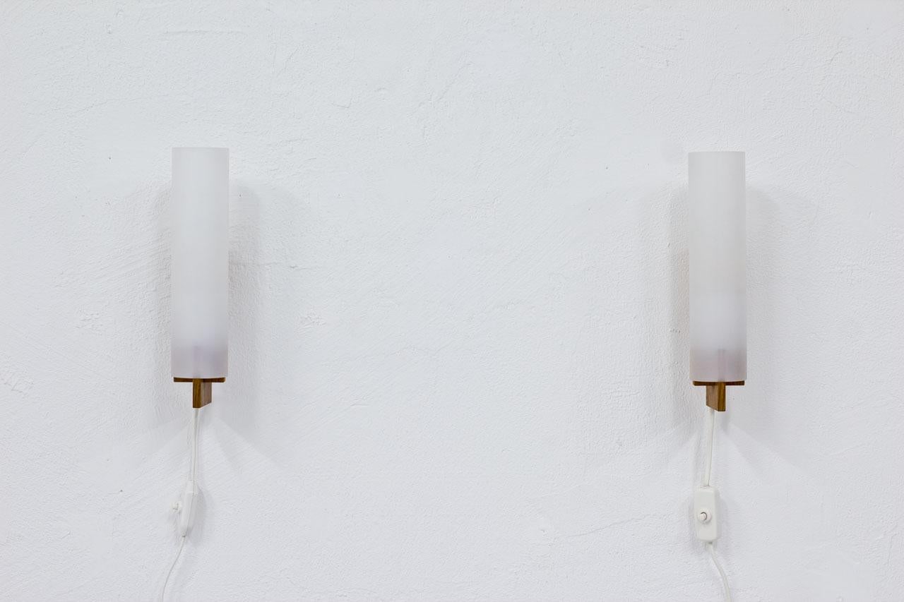Pair of wall lamps designed by
Uno and Östen Kristiansson for
Luxus. Manufactured in Sweden
During the 1960s. Oak frame with
Acrylic diffuser.