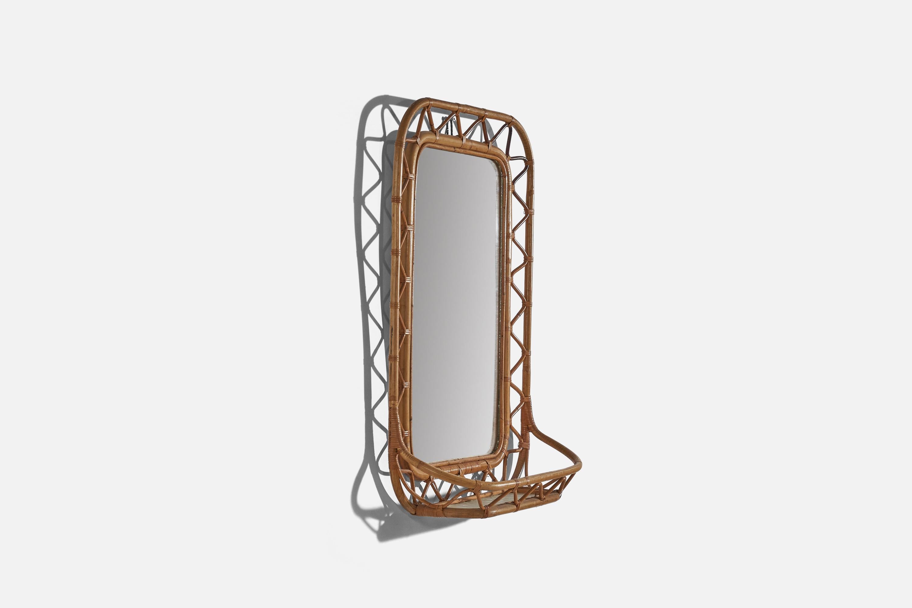 A bamboo and rattan wall mirror with shelf, designed and produced in Sweden, 1960s.