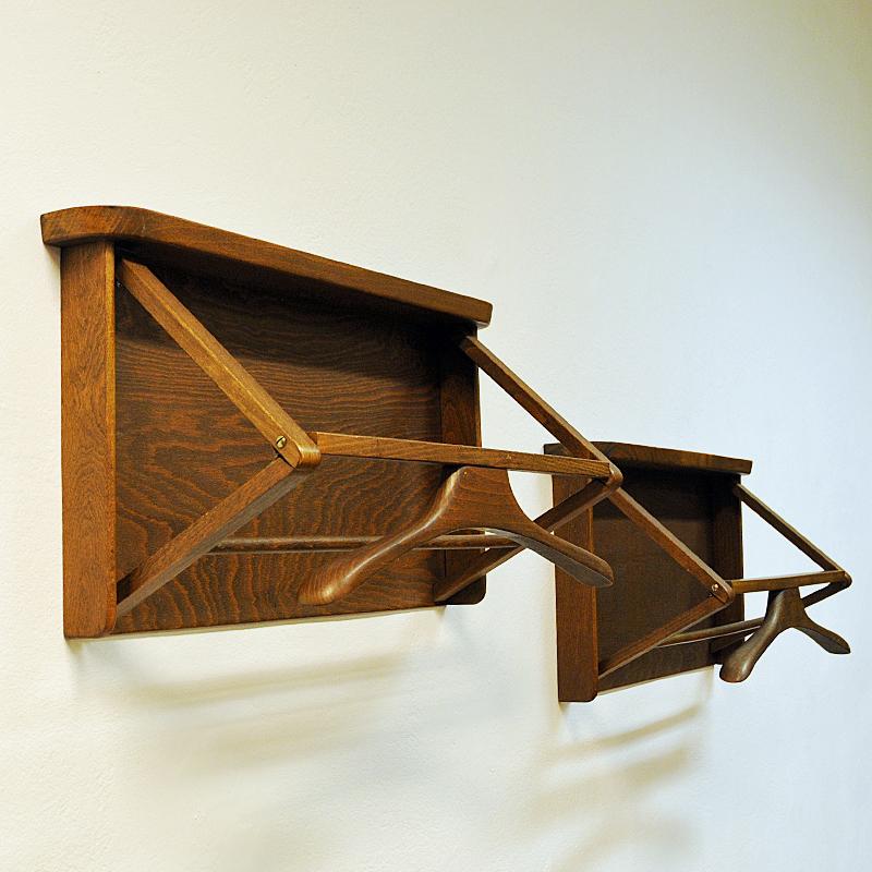 A wall mounted valet or rack designed and made by Per Granebo AB, Farsta - Stockholm – Sweden, 1970s. Solid stained wood with a clothing hanger included. Perfect for the hall or bedroom. Get just one or the pair. Nice design. Good vintage condition.