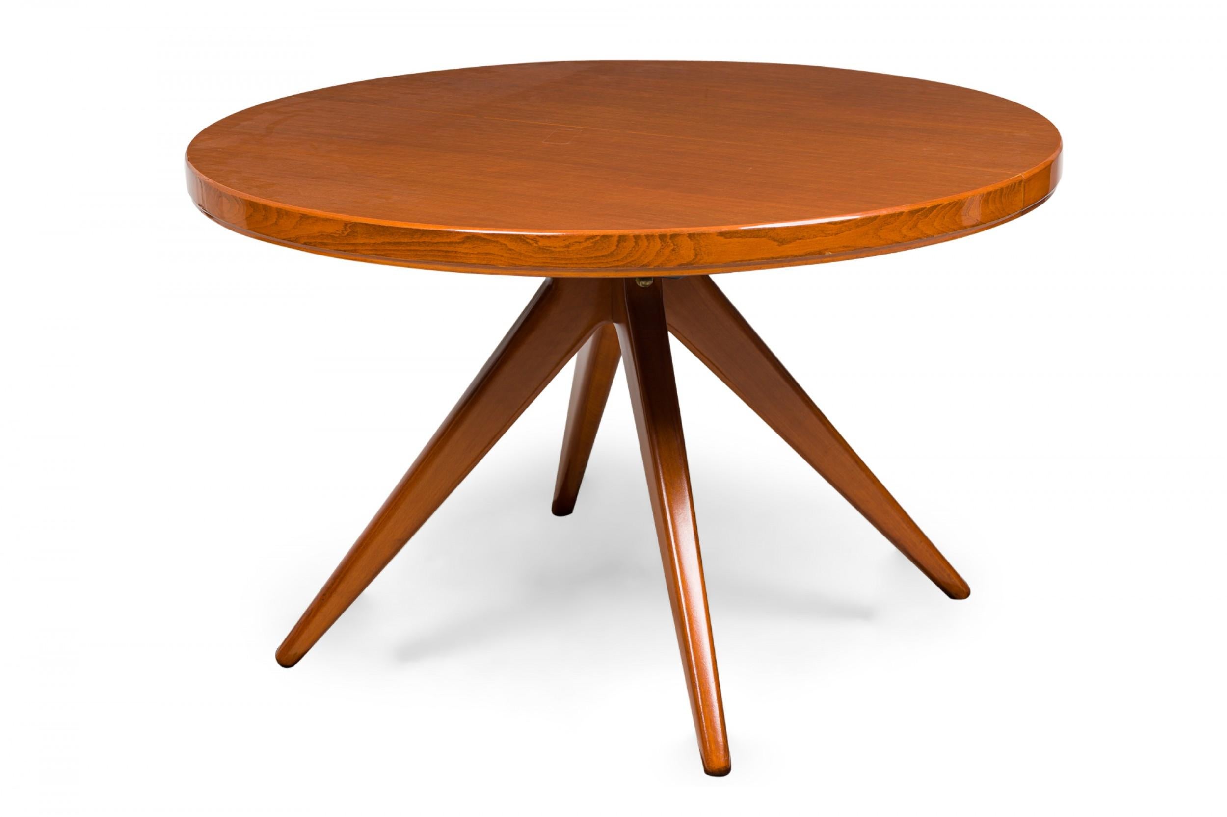Swedish Mid-Century Modern circular extension dining / center table with two removable leaves, resting on four center-mounted tapered wooden legs. (attributed to ERNO FABRY)

With leaves extended: 94