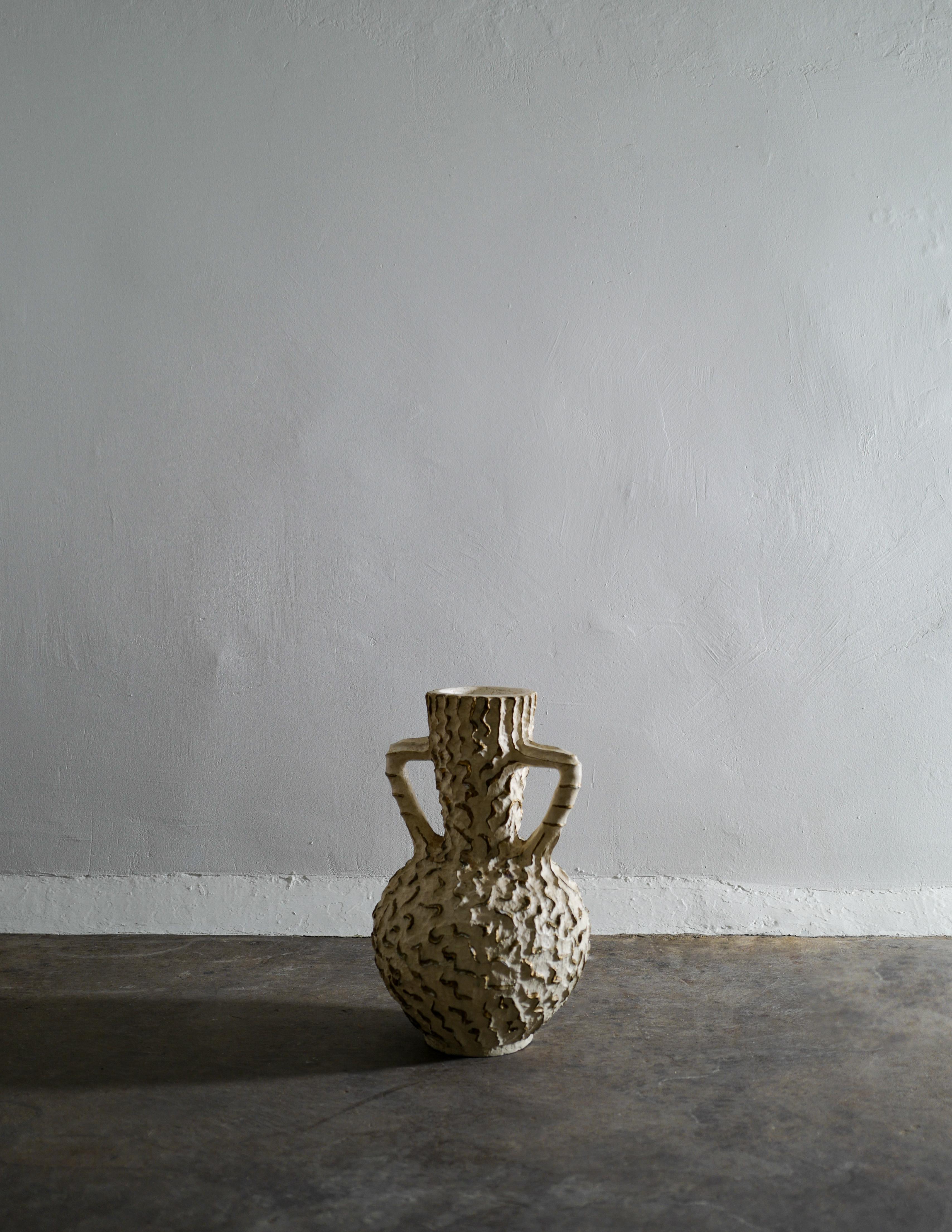 white and gold floor vase