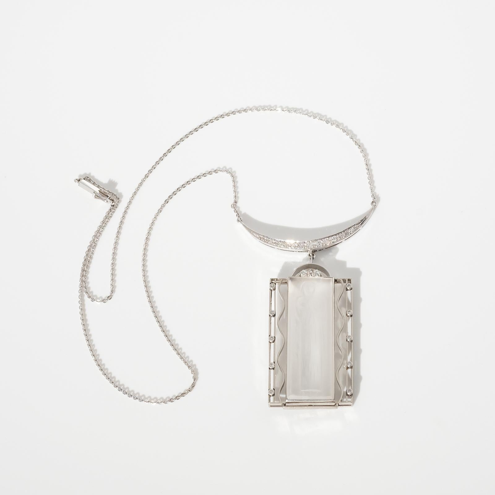 This necklace and pendant are made out of 18 karat white gold, 28 diamonds and rock crystal. Engraved in the rock crystal is an image of the Italian saint Saint Lucia.

Did you know that this shimmering necklace, referred to as the Lucia jewelry,