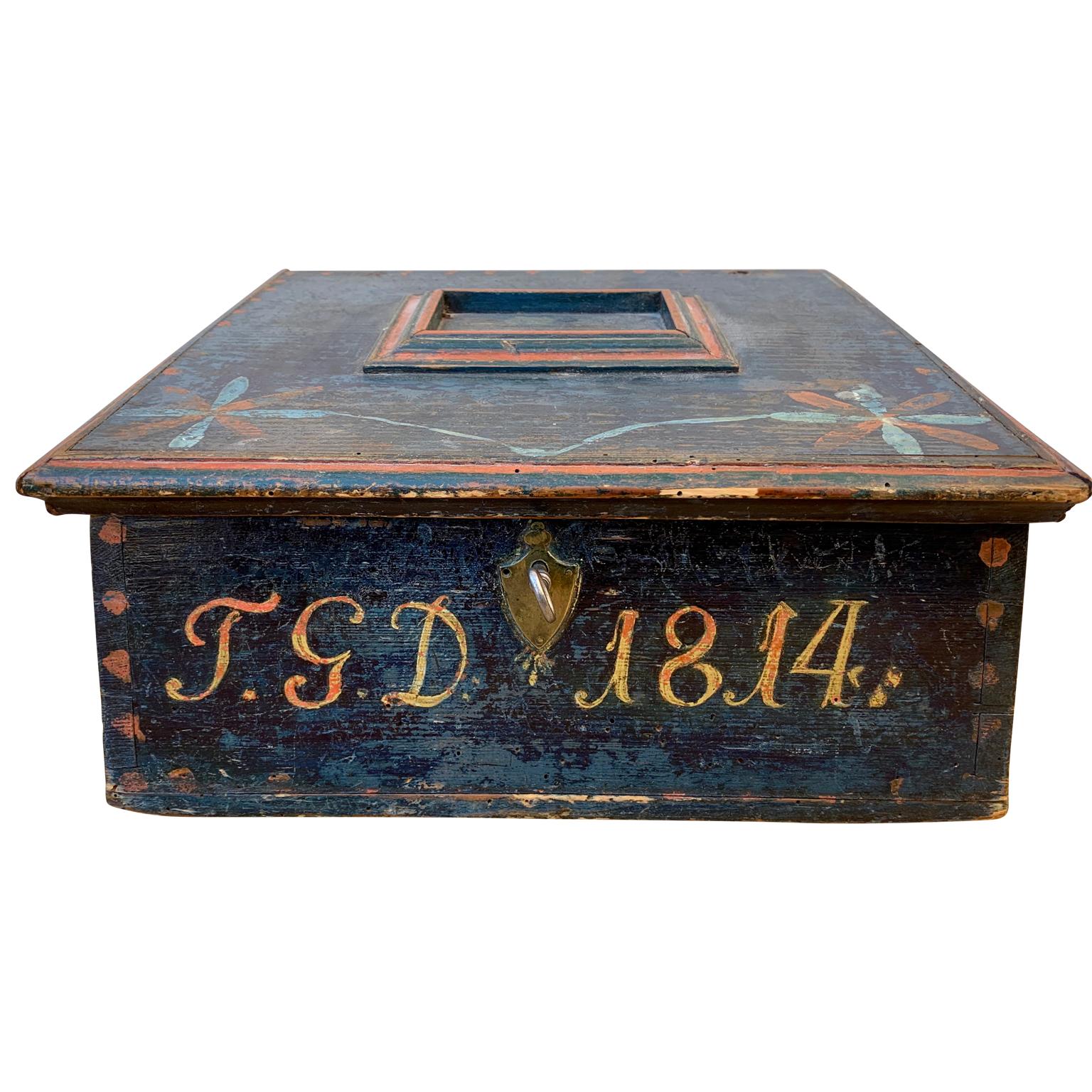 A 19th Century Swedish original blue painted Folk Art box with original polychrome decoration. Dated 1814 with the initial of the female owner IGD, most likely used to keep writing supplies and office materials.
With original lock and key, it was