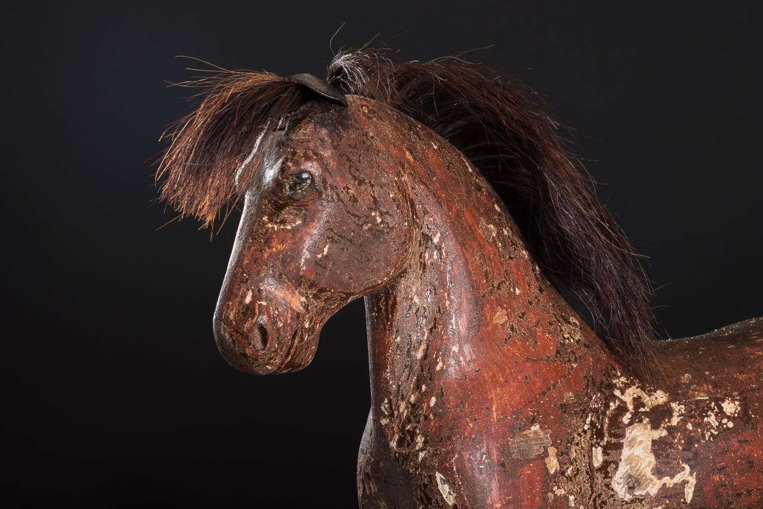 Handcrafted horse in wood with original paint Tail and mane made with real horsehair and ears in leather. The horse was manufactured during the 1800s and originates from a village called Järvsö.