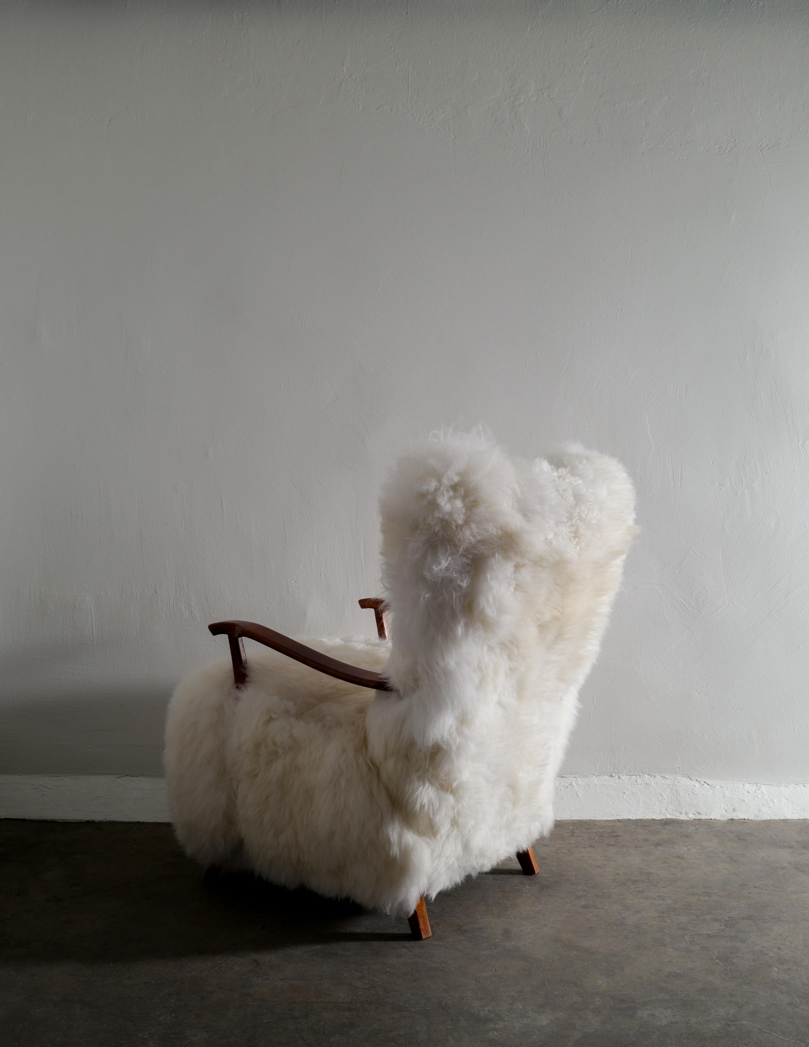 Scandinavian Modern Swedish Wooden Mid Century Armchair with Sheepskin Produced in Sweden 1960s