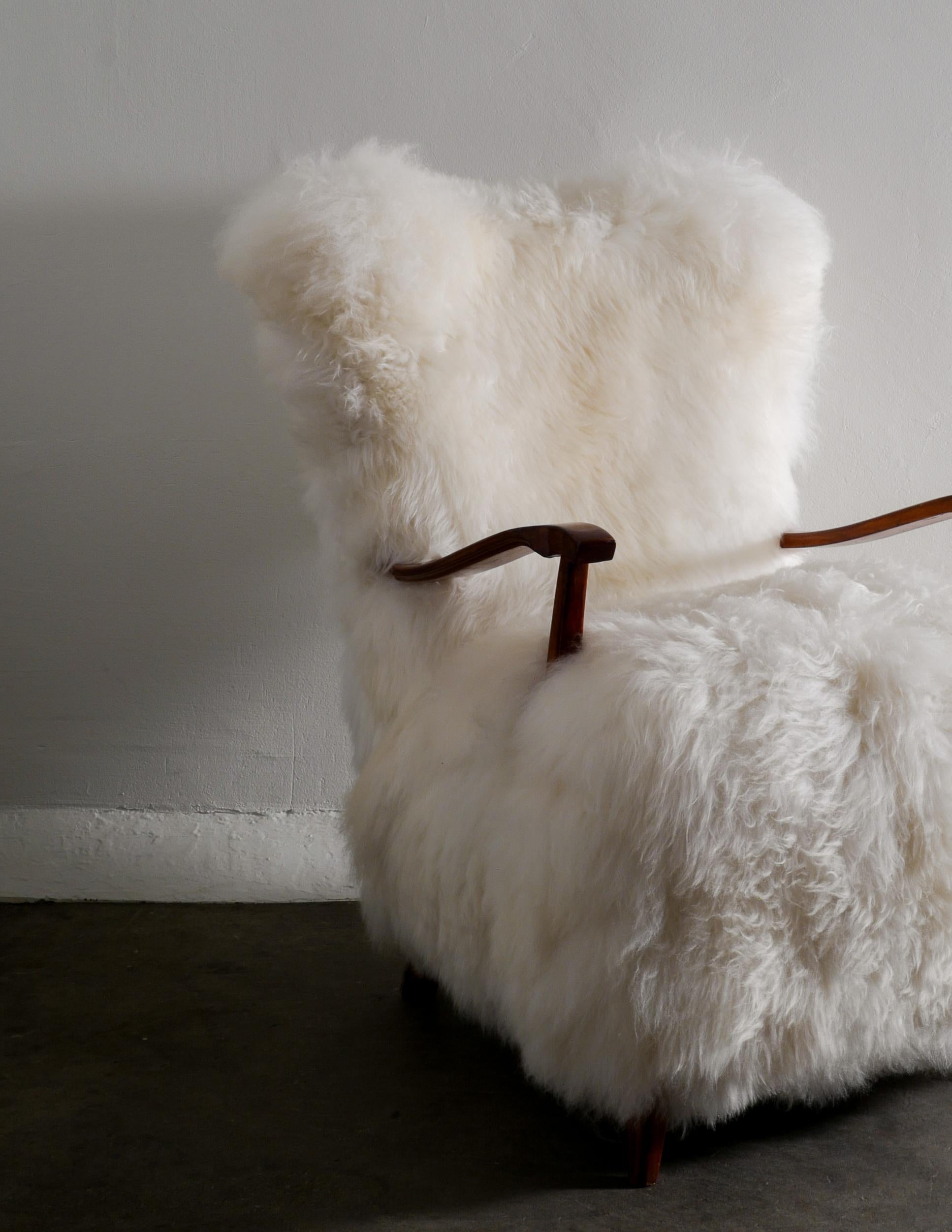 Mid-20th Century Swedish Wooden Mid Century Armchair with Sheepskin Produced in Sweden 1960s