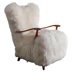 Swedish Wooden Mid Century Armchair with Sheepskin Produced in Sweden 1960s