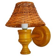 Swedish wooden sconce and rattan shade, a Wall Lamp by Smålandsslöjd Sweden