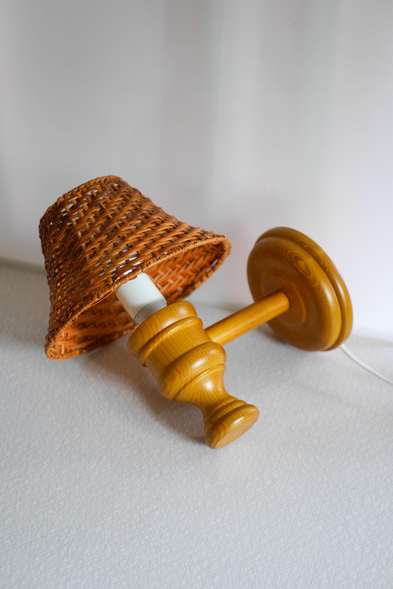 Mid-Century Modern Swedish wooden sconce and rattan shade, a Wall Lamp by Smålandsslöjd Sweden For Sale