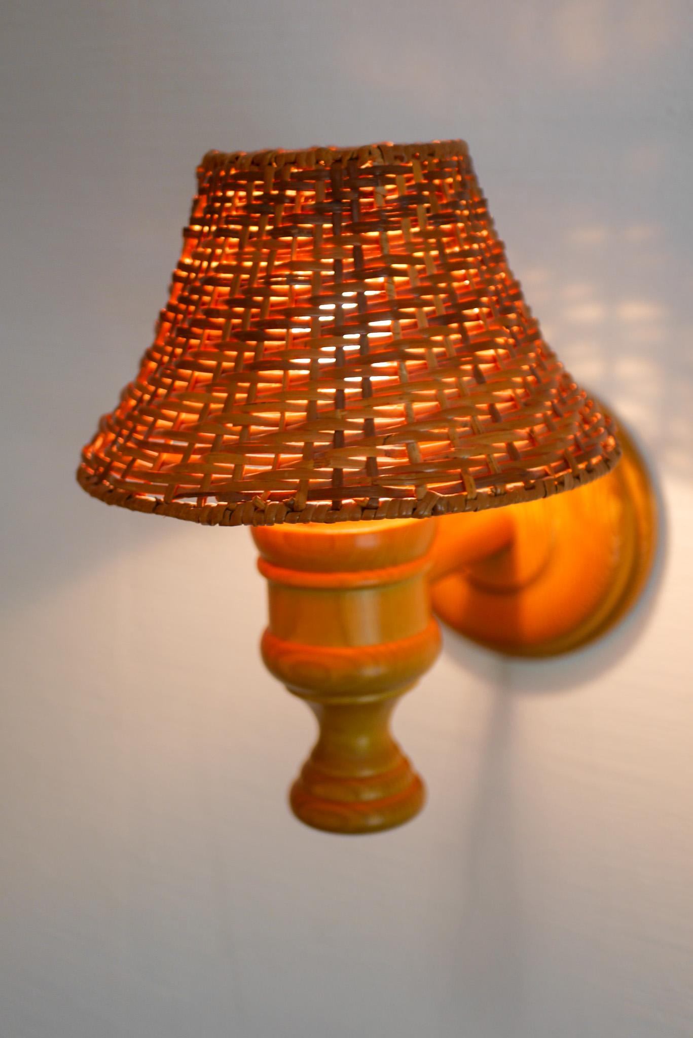 Hand-Crafted Swedish wooden sconce and rattan shade, a Wall Lamp by Smålandsslöjd Sweden For Sale