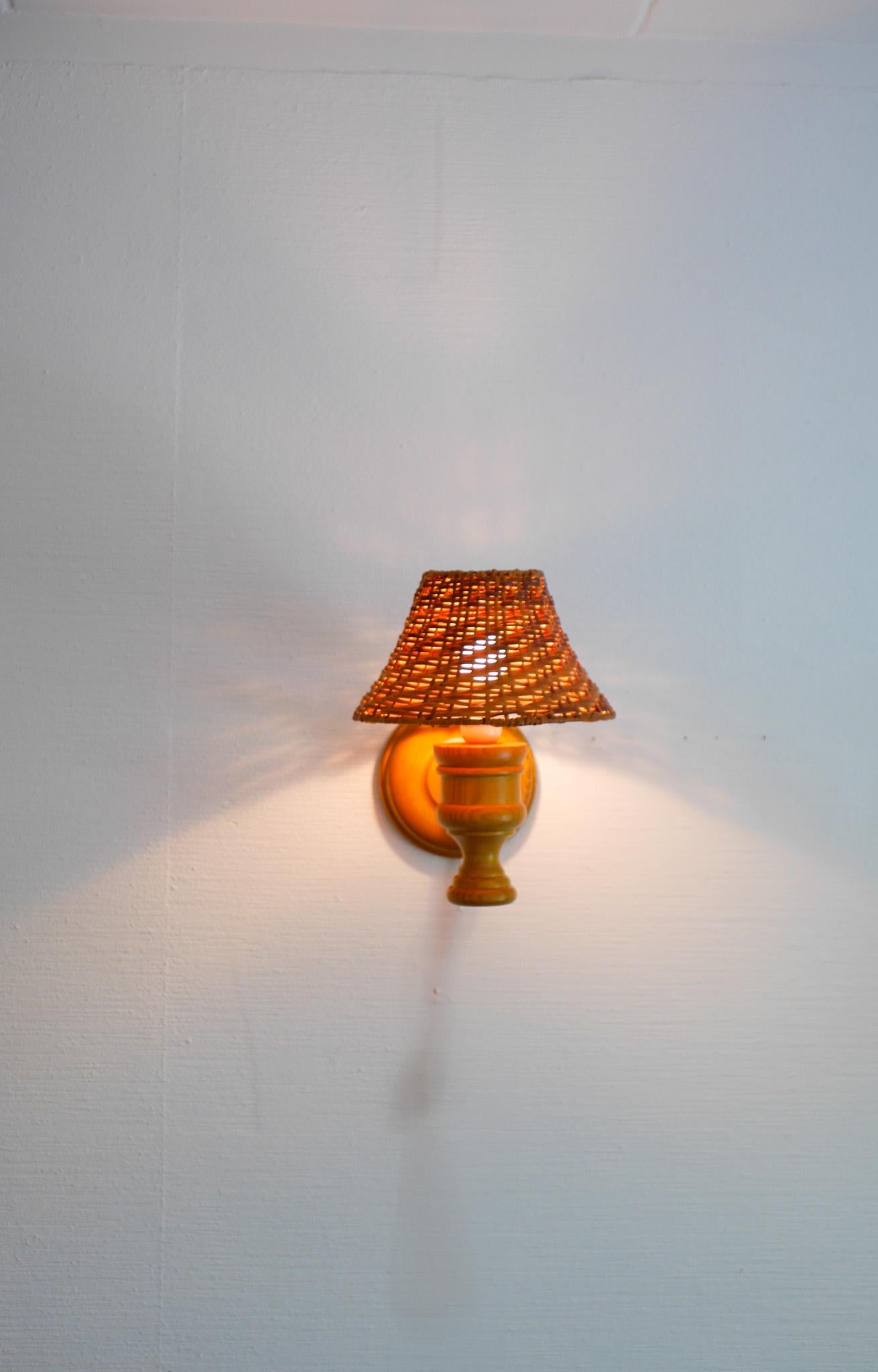 Swedish wooden sconce and rattan shade, a Wall Lamp by Smålandsslöjd Sweden For Sale 1