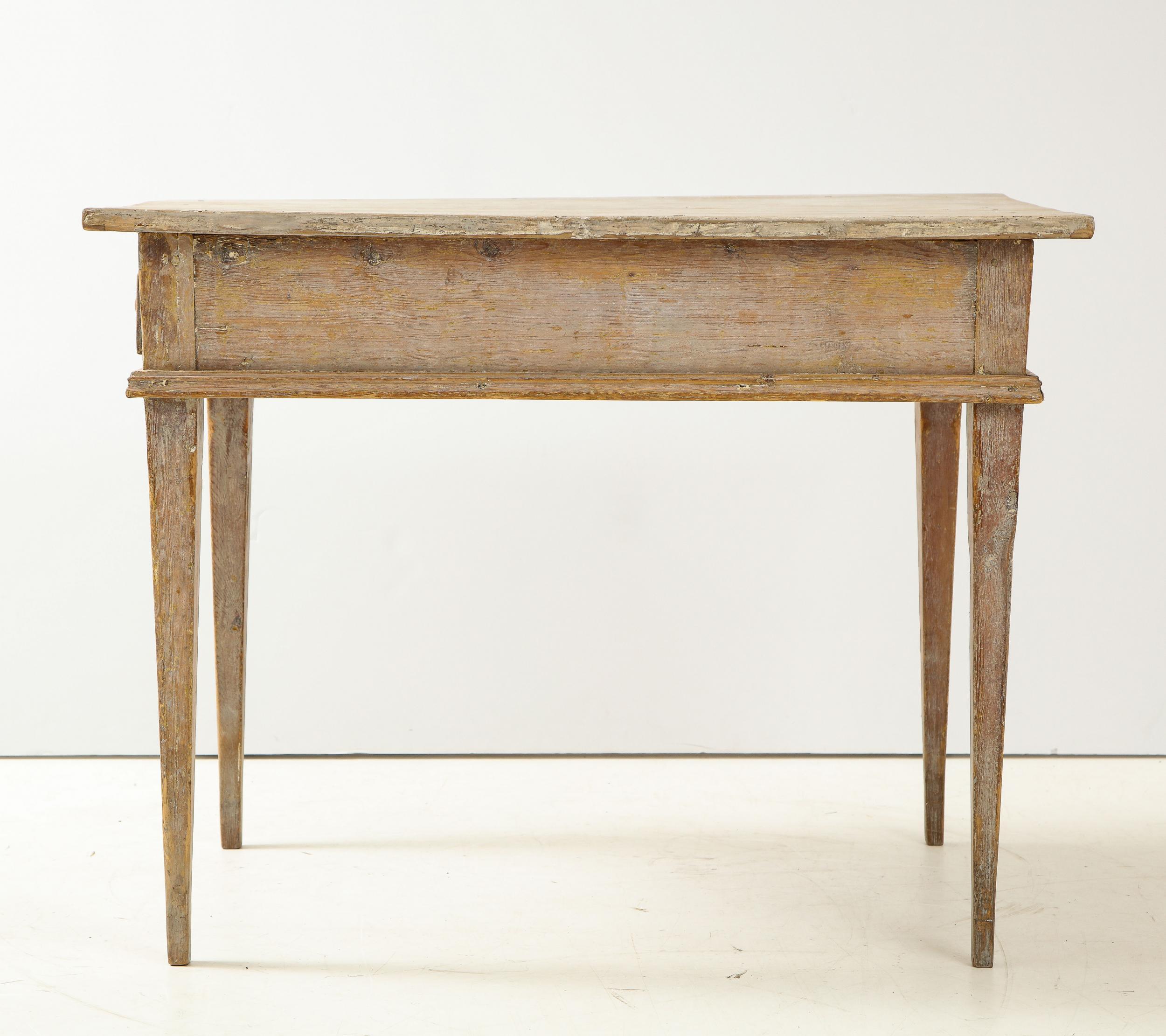 Late 19th-century Swedish writing desk or side table on tapered legs. Stripped back to the pine, remnants of grey and cream paint remain. The single drawer has dovetail joinery and the original know.