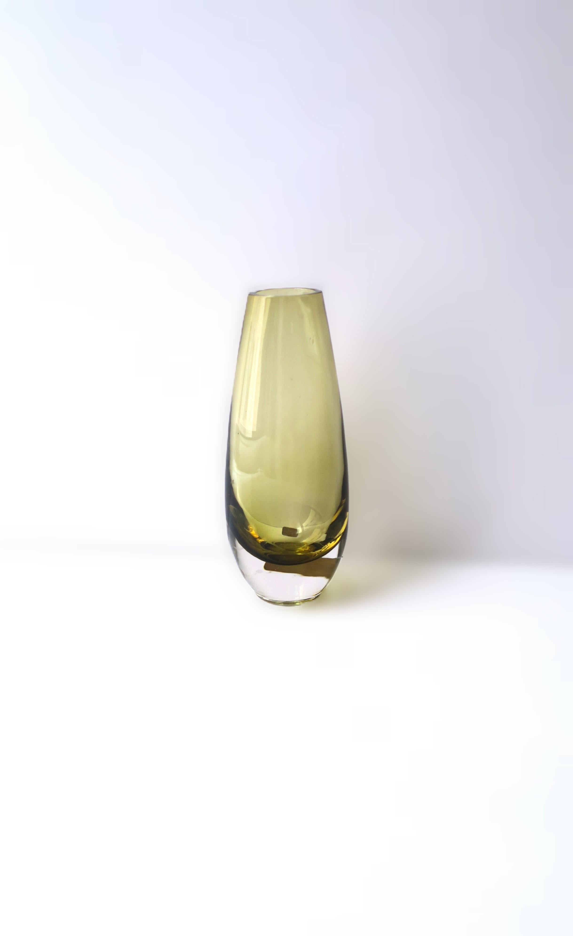 A Swedish light-yellow glass vase, Midcentury Modern Scandinavian Modern, Sweden, circa mid-20th century. Very good condition as shown in images and video. Markers' mark as shown in image. A great piece for a desk, table, shelf, etc. Measures: 7.25