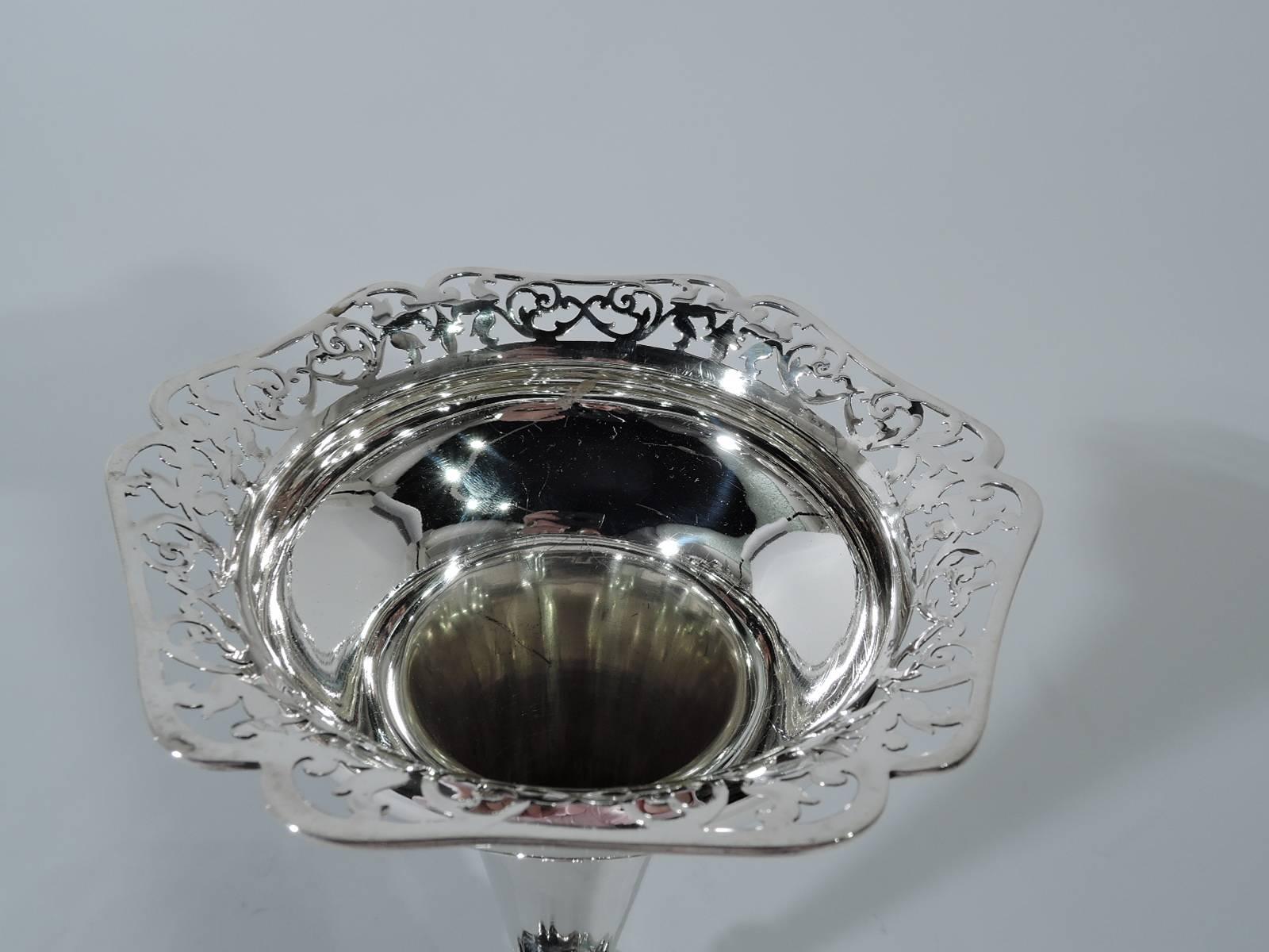 George V sterling silver vase. Made by James Woods & Sons in Birmingham in 1912. Conical body terminating in knop on raised and scrolled foot. Bellied top with pierced and scrolled rim. Sweet and pretty. Hallmarked. Weighted.