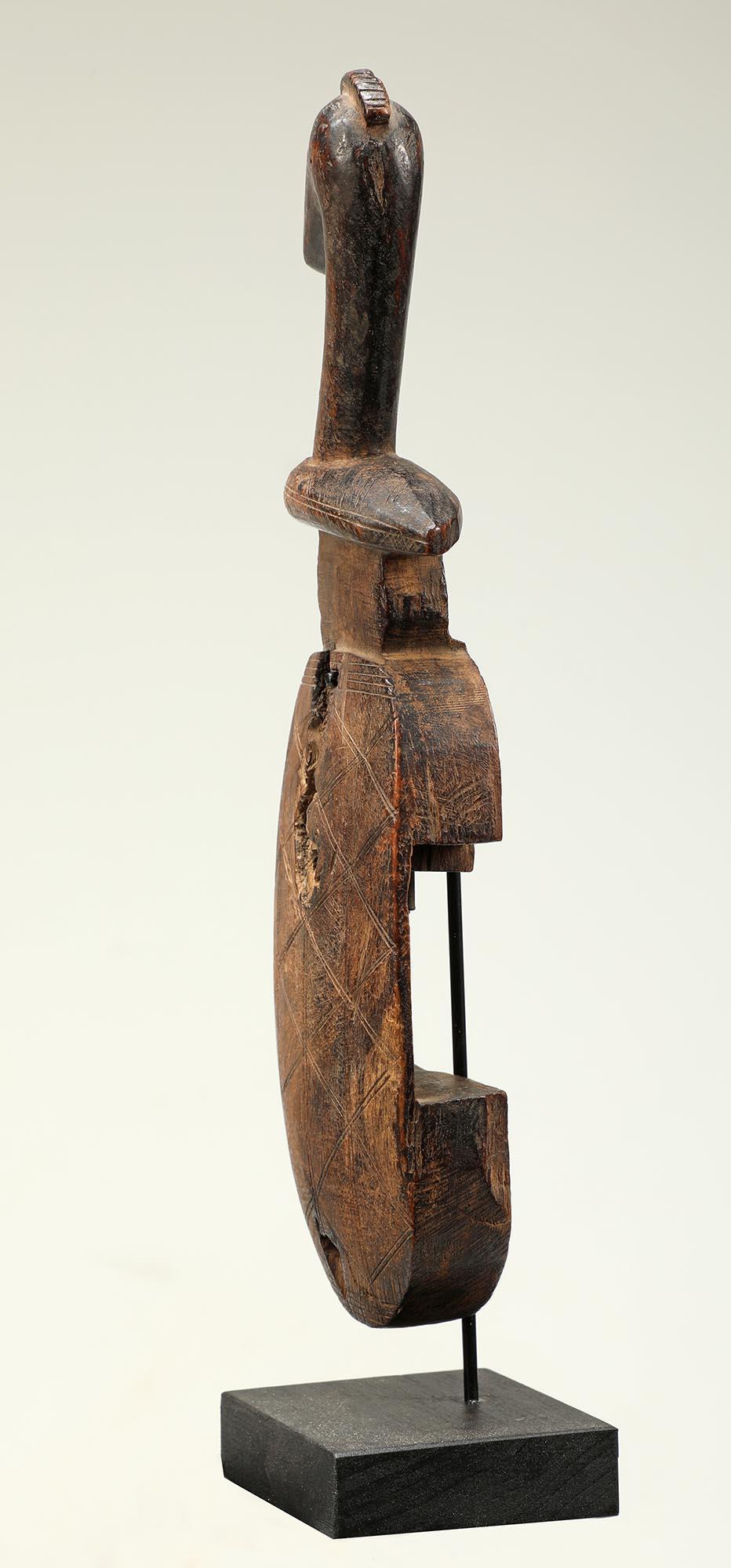 A very sweet small sized carved wood bird topped door lock from the Bambara people of Mali Africa. Originally would have had a horizontal sliding cross bar lock, now missing. Mounted on custom metal and wood stand. Wear and polish from use, some