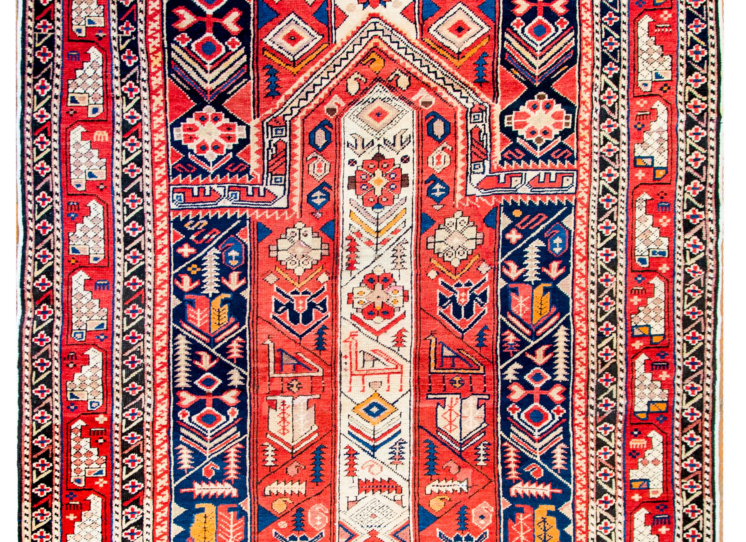 A sweet early 20th century Azerbaijani prayer rug with red, white, and blue stripes, each with stylized flowers, leaves, and birds surrounded by a simple border of a large-scale stylized floral pattern flanked by a pair of matching petite floral