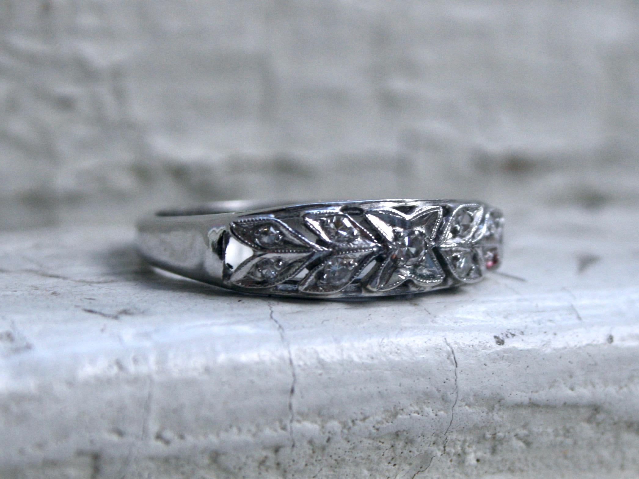 This Sweet Floral Vintage find would make a great wedding band or stackable! Crafted in a 14K White Gold, the band features a wonderful leafy design with Pave Set Diamonds. There are a total of 9 Single Cut Diamonds, totaling approximately 0.18ct,