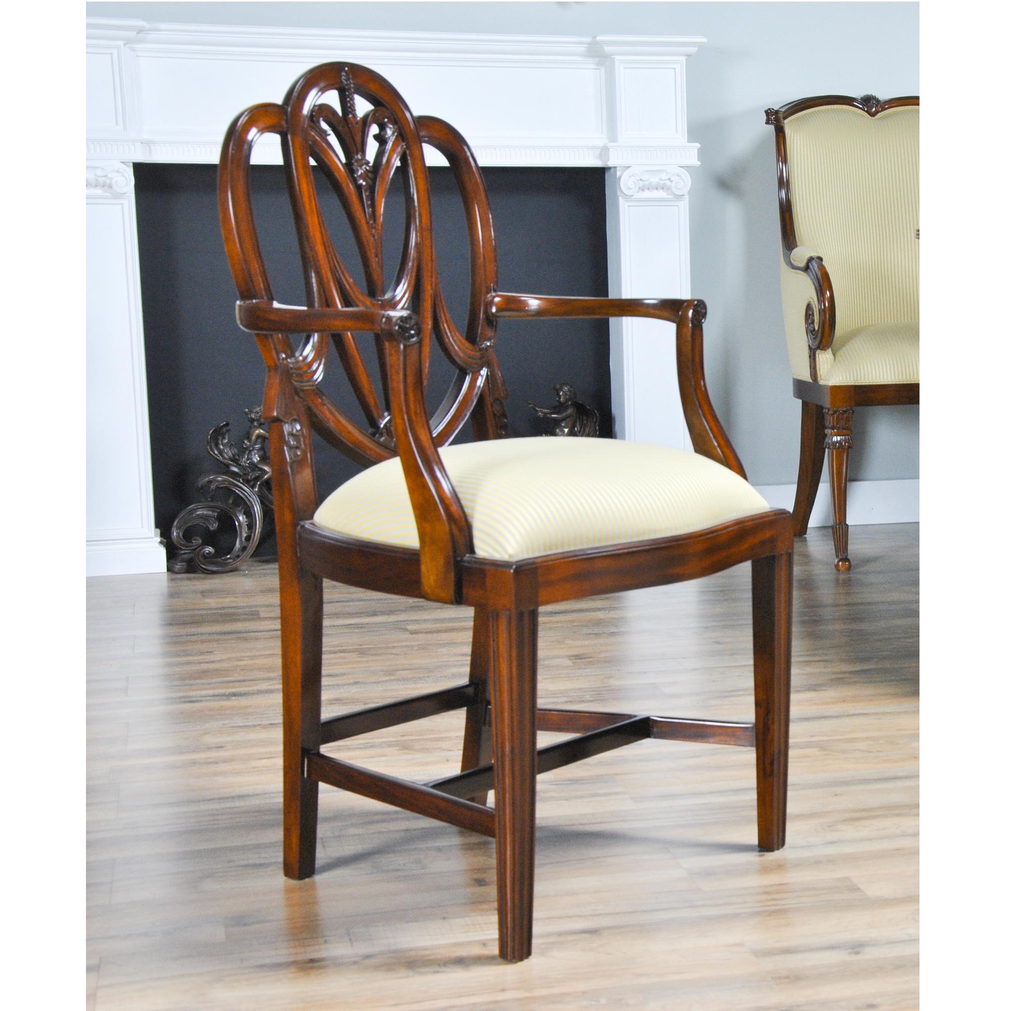 A set of 10 Solid Mahogany Sweet Heart Dining Chairs, the set consisting of 2 arm chair s and 8 side chairs. This style of chair are also known as a Heart Shaped Chairs. They have an elegant and stylish back featuring Drape Carvings as well as