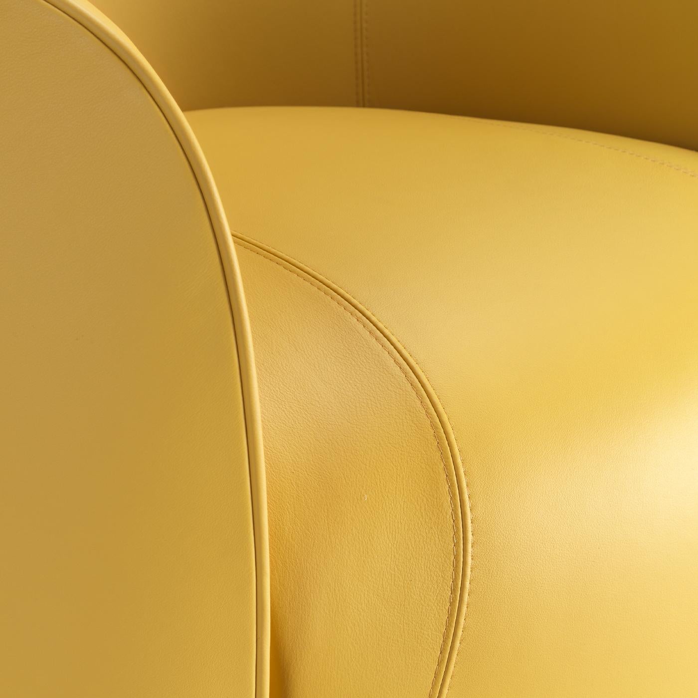 Ideal to infuse a dash of lively character to dull waiting rooms or living rooms, this armchair is inviting in its seamless juxtaposition of curves tracing plush volumes wrapped in soft, mustard leather. The backrest's arched profile slopes at the