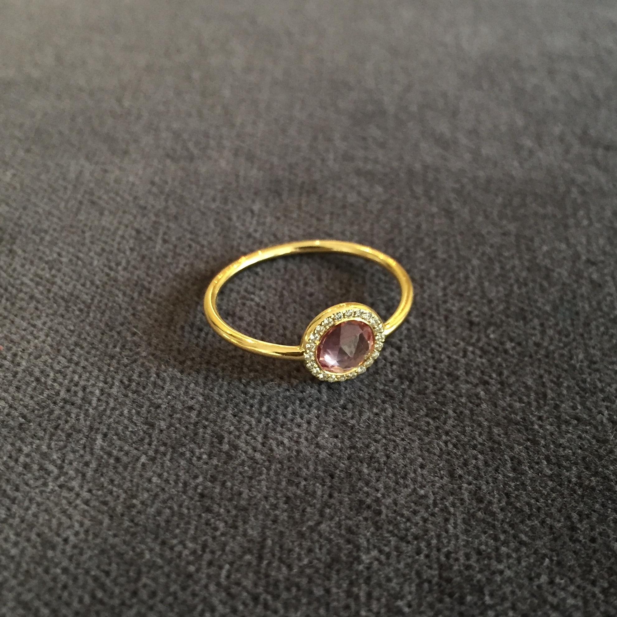 A one of a kind engagement ring from Sweet Pea made in 18k yellow gold. The pink rose cut 0.69ct sapphire is encircled by white diamonds with a total weight of 0.05ct. This ring is a UK size L.

This stunning unique 18ct yellow gold ring is set with