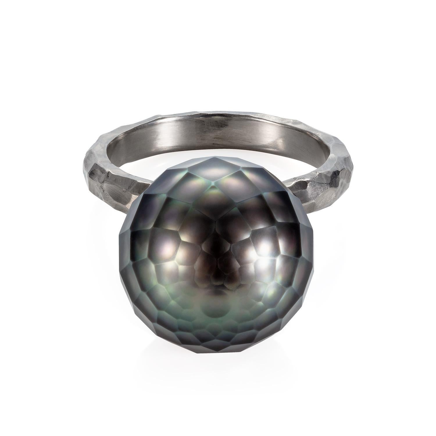 A very unique ring by Sweet Pea, made in 18k white gold. The hammered band is 3mm wide and has a brushed finish. The black Tahitian pearl is 14.5cm diameter and truly is a piece of art in itself. This one-off piece is a UK ring size M and will be