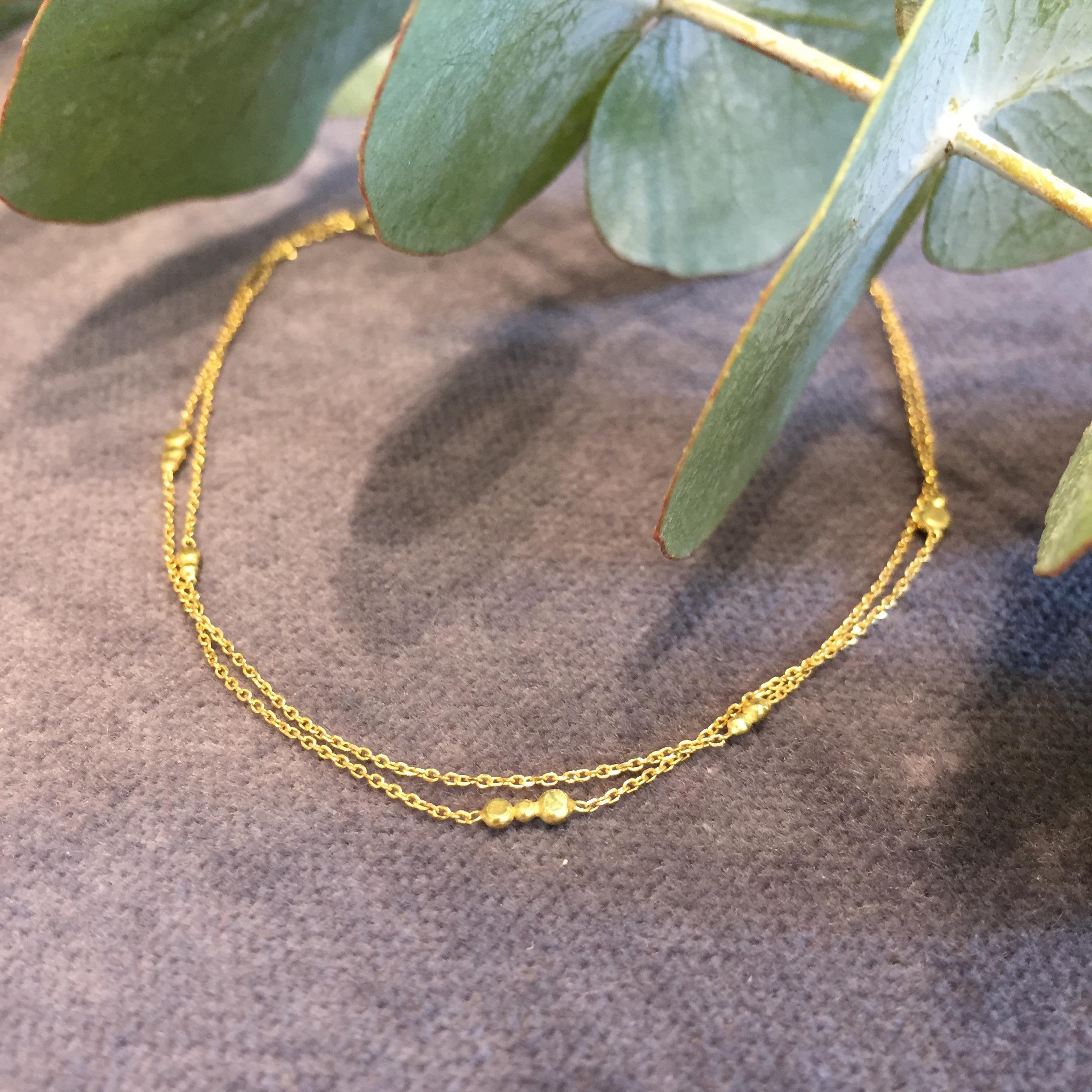 Sweet Pea double chain bracelet from the Bits and Bobs collection, handmade in 18k yellow gold. The total length of this bracelet is 17cm but it can be ordered in any required length. This gorgeous bracelet features gold disc details set by hand