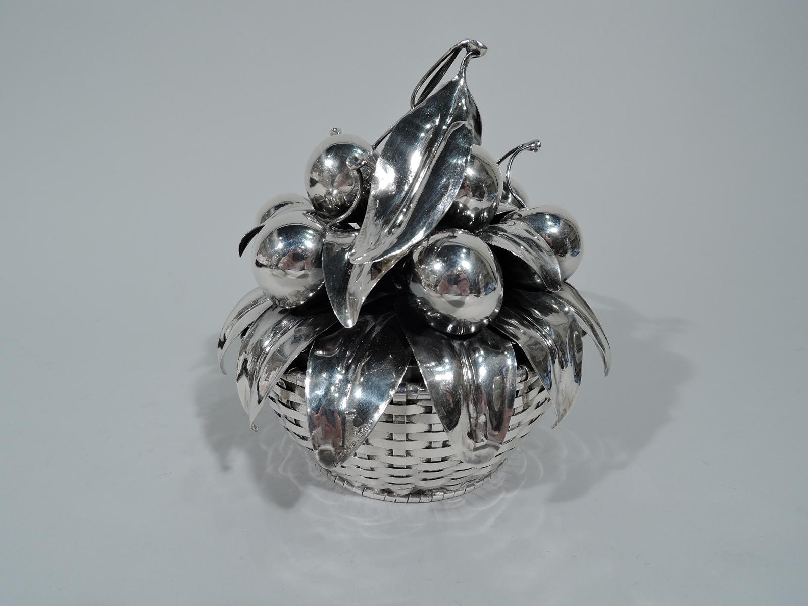 Sweet sterling silver basket. Made by Buccellati in Milan. Solid well and curved woven sides. Cover in form of overlapping leaves mounted to open circular frame with more leaves and cherries heaped on top. Succulent fruit with leafy stems. Post-1967