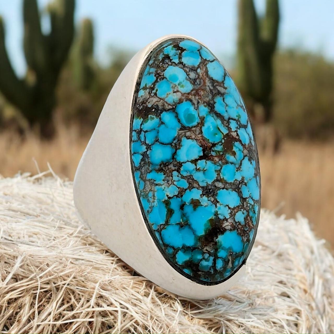 New sterling silver ring made by Rob Sherman with a stunning Kingman turquoise cabochon in bright blues with a black matrix.

Introducing the Sweetwater Hill ring, a beautifully handcrafted sterling silver piece designed by the talented artisan Rob