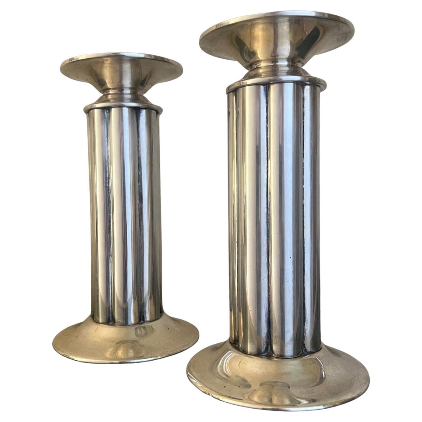 Set of two stamped Swid Powell Candlesticks, made in Italy in the 1980's. Designed and stamped with architect Robert A.M. Stern's initials. The pattern is called 