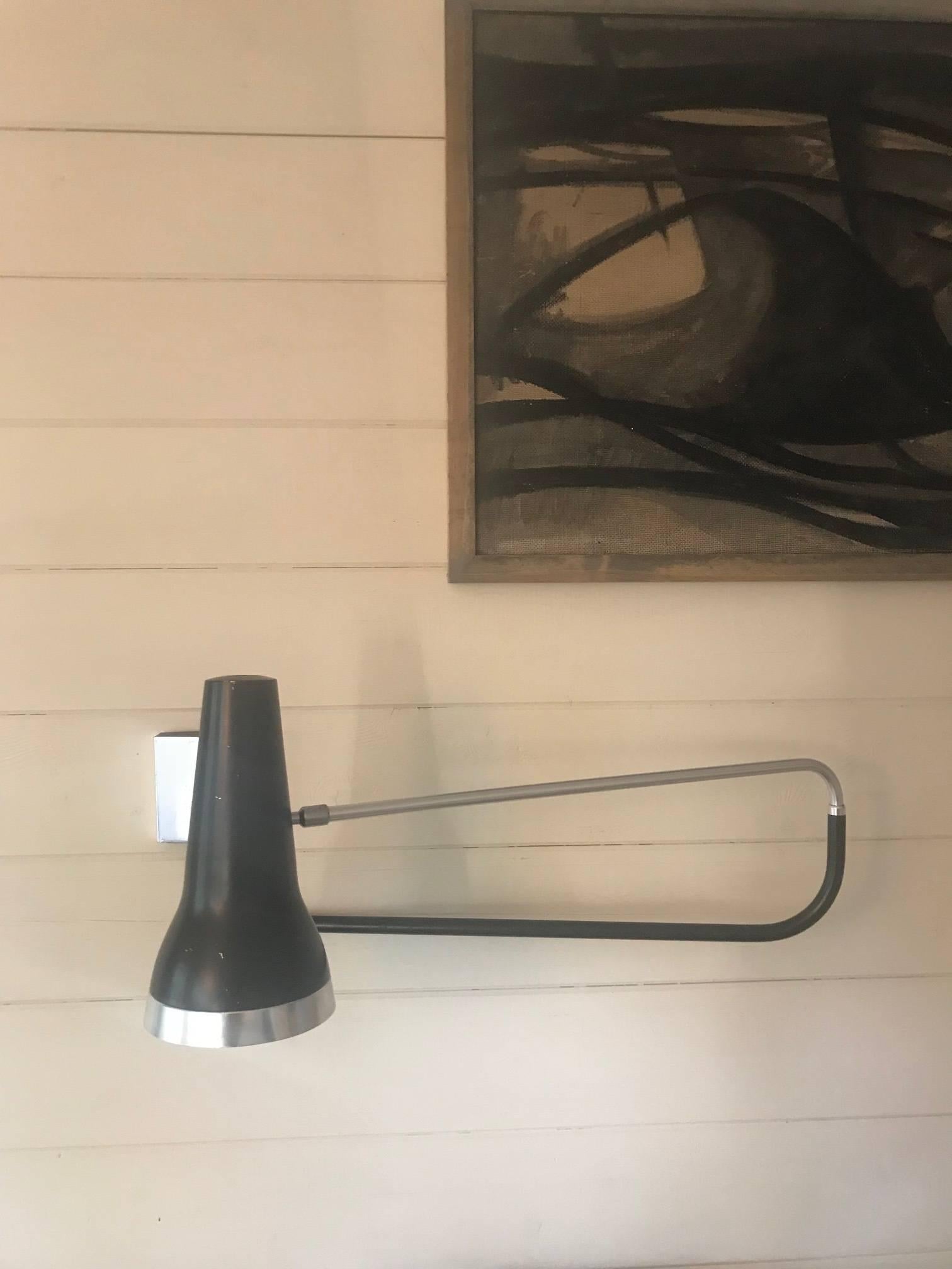A double hinged swing arm wall light designed by E.Cooke for Cone Fittings Ltd UK. Adjustable reflector, rim and outer rim in anodized aluminium, shade in black. Maximum extension 91cm.
