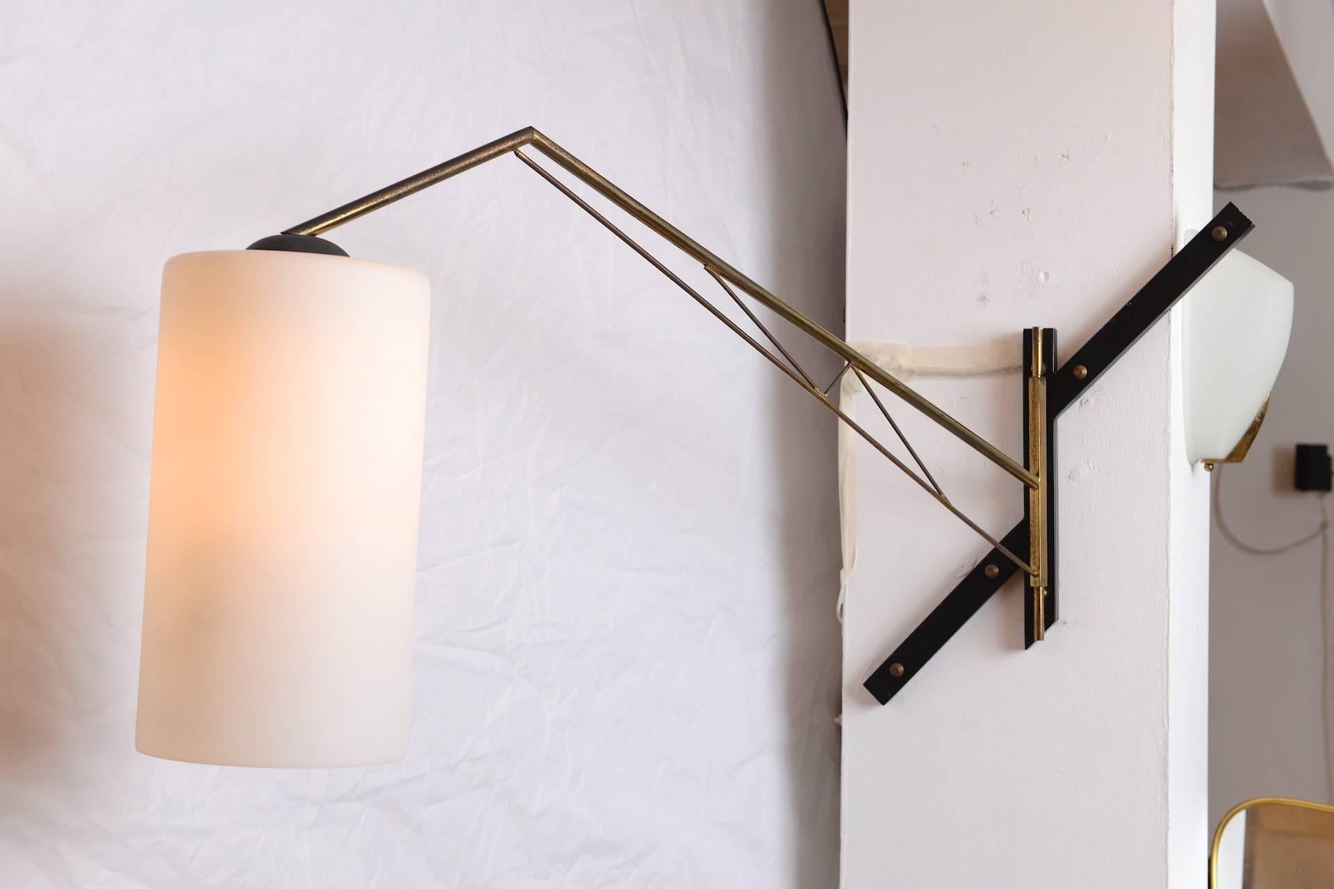 Brass and opaline shade wall light with swing arm.