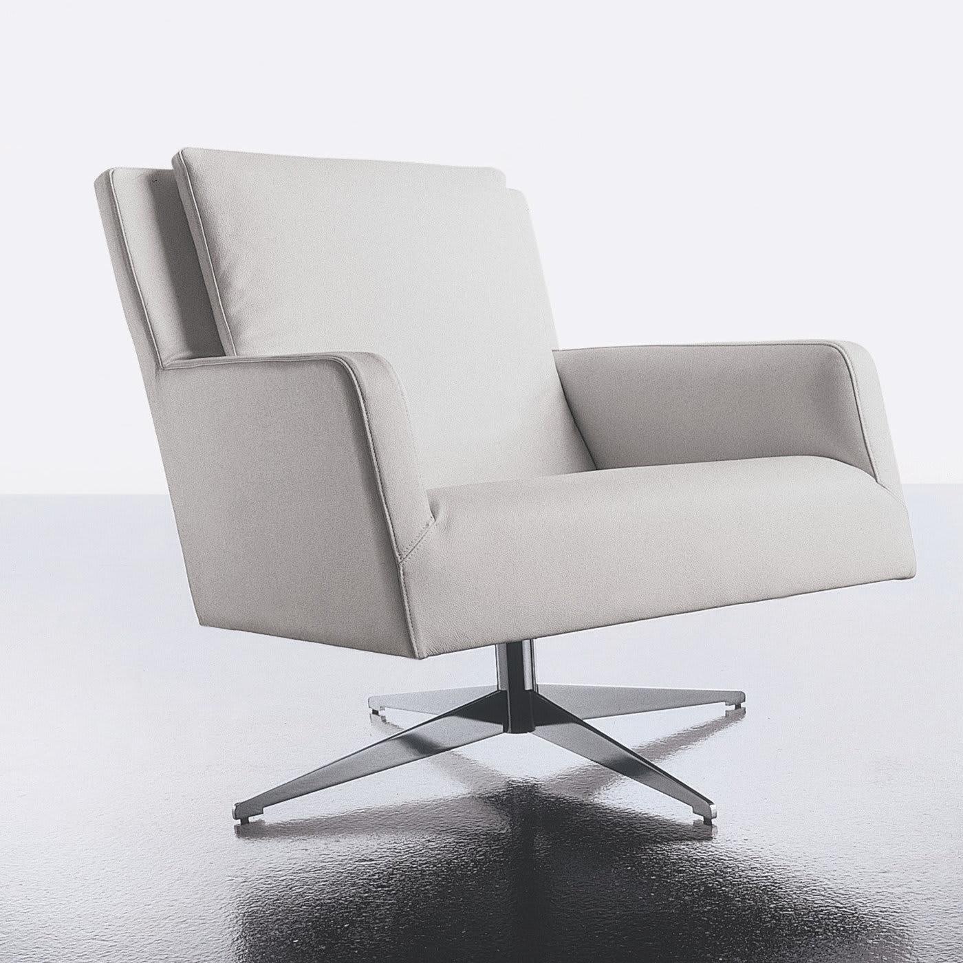 This swivel lounge armchair sits atop a four-spoked, stainless steel base. Its structure is made out of beech plywood, while white, genuine leather covers its padded seat and back. The wide, roomy design of this chair ensures maximum comfort. It is