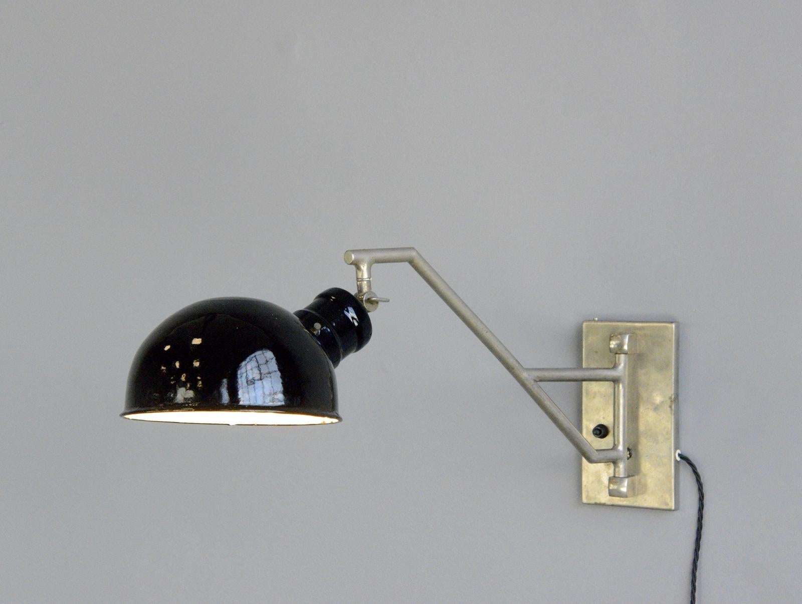 Swing out wall lamp by Kugella, circa 1930s

- Vitreous black enamel shade
- Nickel swing out arm
- On/Off switch on the wall plate
- Takes E27 fitting bulbs
- Made by Kugella, Mittelschmalkalden 
- German ~ 1930s
- Measures: 64cm deep x