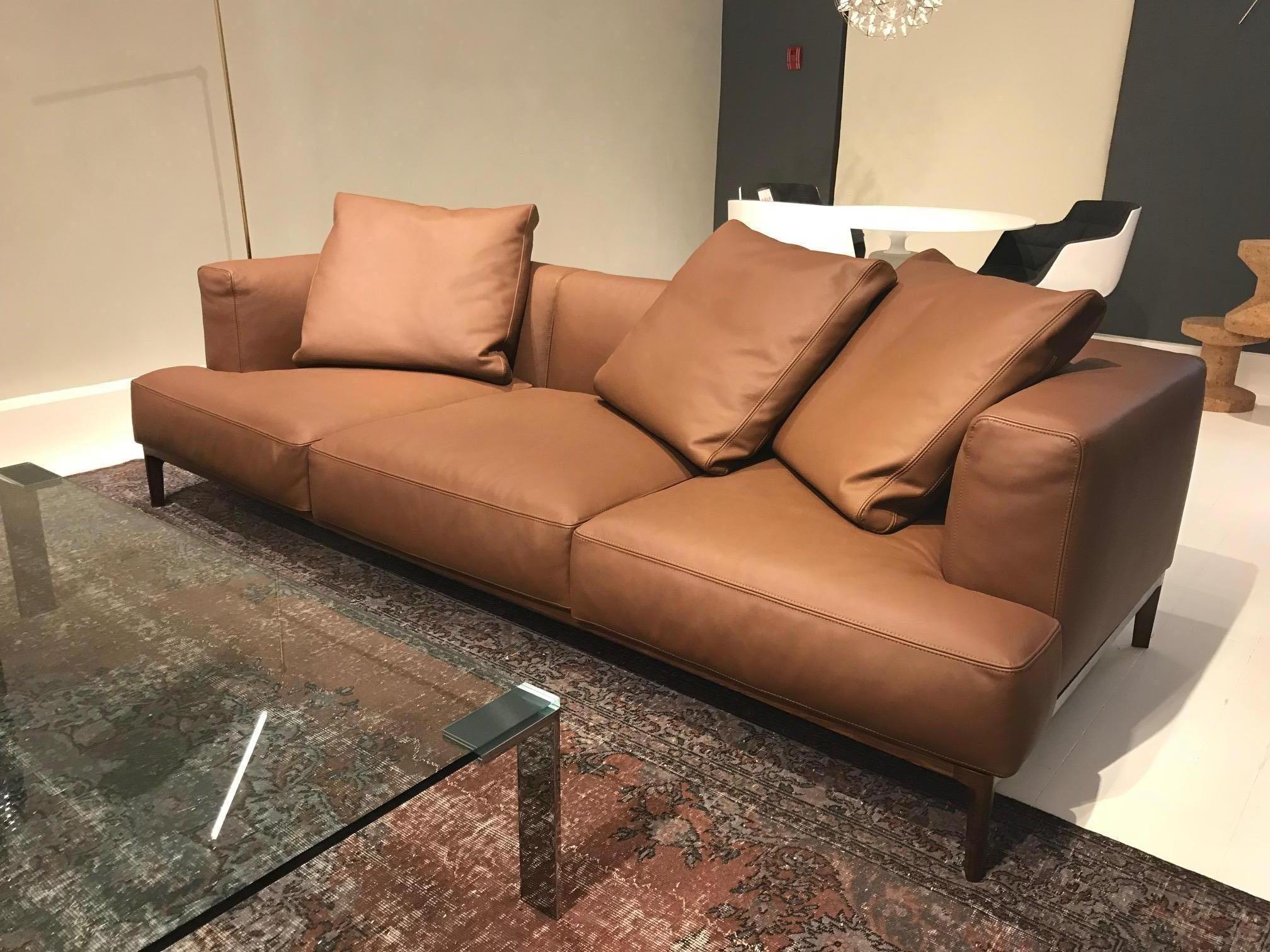 Swing three-seat sofa as shown in a top-grade brown leather and walnut base. Modern and elegant and perfect for any living room or lounge area. Designed by Bavuso Giuseppe in 2015. 

Dimensions: 94.5” L x 39.4
