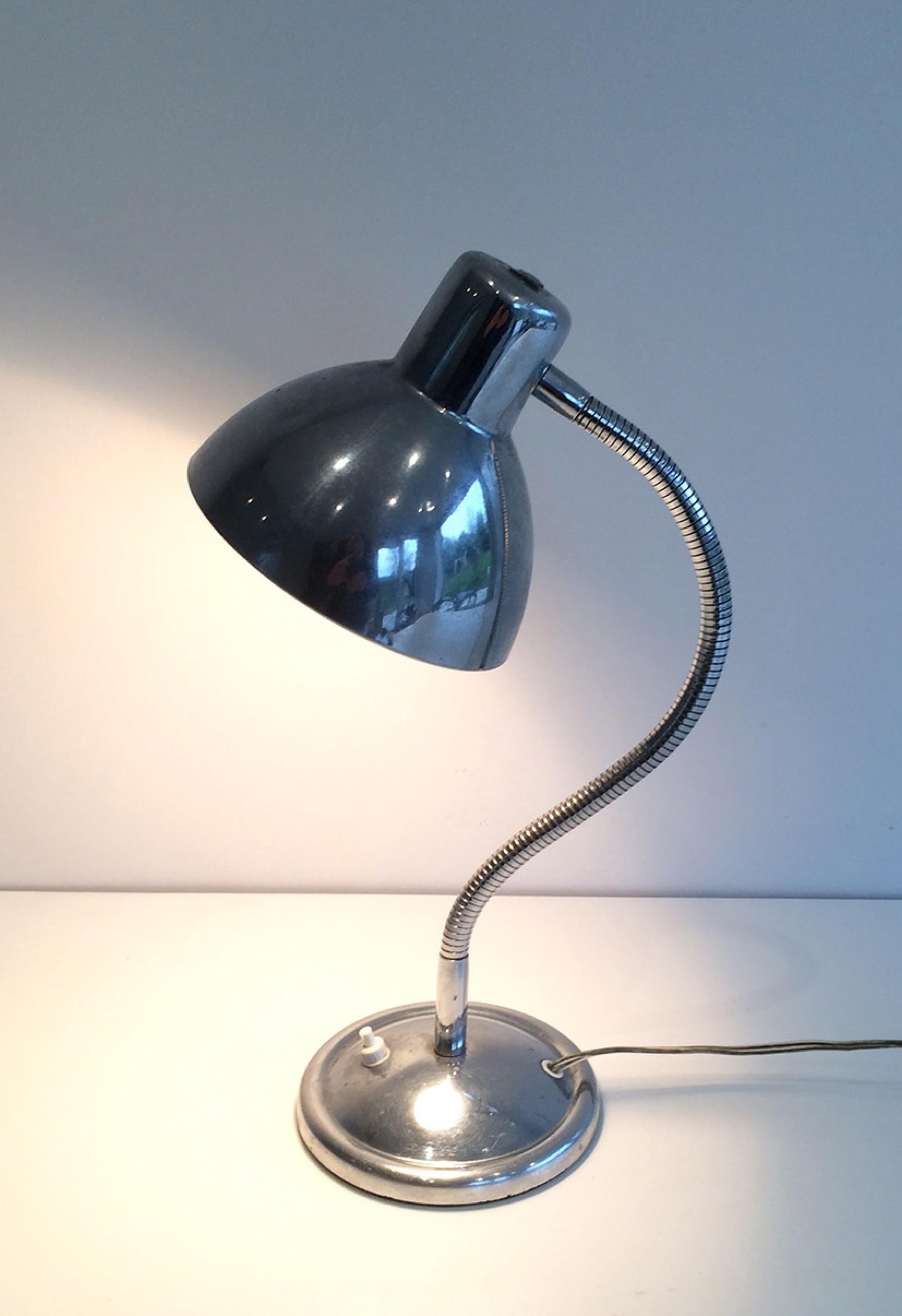 This swinging table lamp is made of chrome. This is a French work, circa 1960.