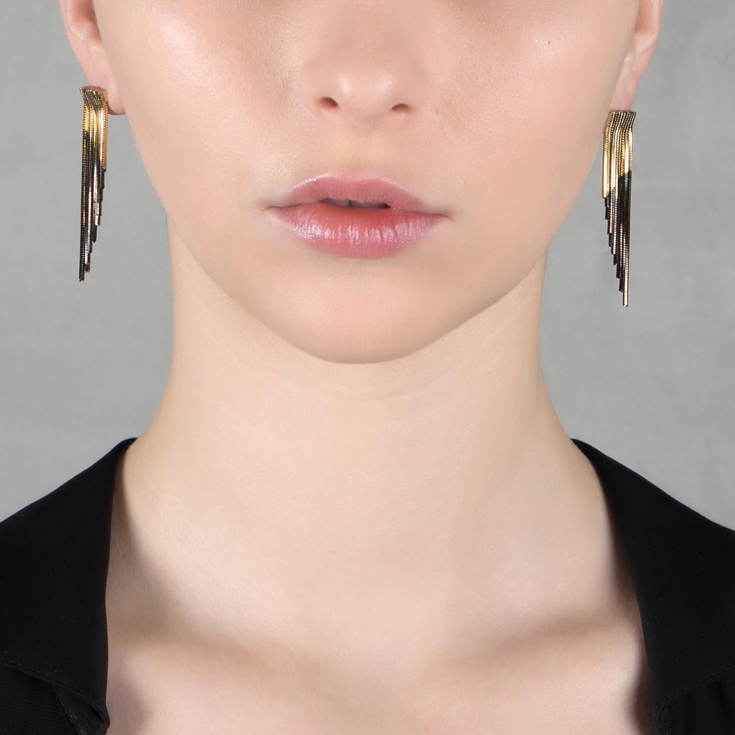 Classic shapes are updated with the inspiration of wings with this pair of earrings from Iosselliani. Specularly designed, the fringed pair is crafted with a cascade of two tones gold chains to lend swinging glamour to your daliy wear. Butterfly