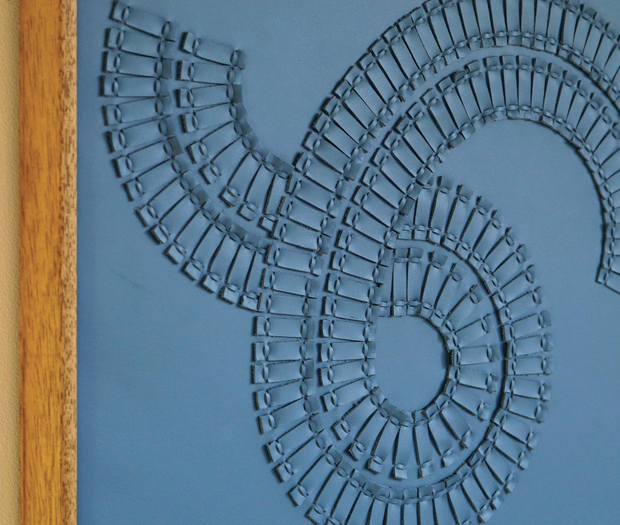 Swirl:

A piece of 3D sculptural wall art designed and made from two layers of cream leather, woven together by Louise Heighes. 
Measurements are 21 x 21 inches or 54 x 54 cm175

These artworks are crafted from two layers of sustainably sourced