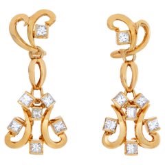 Swirl diamond dangle earrings in 18k yellow gold