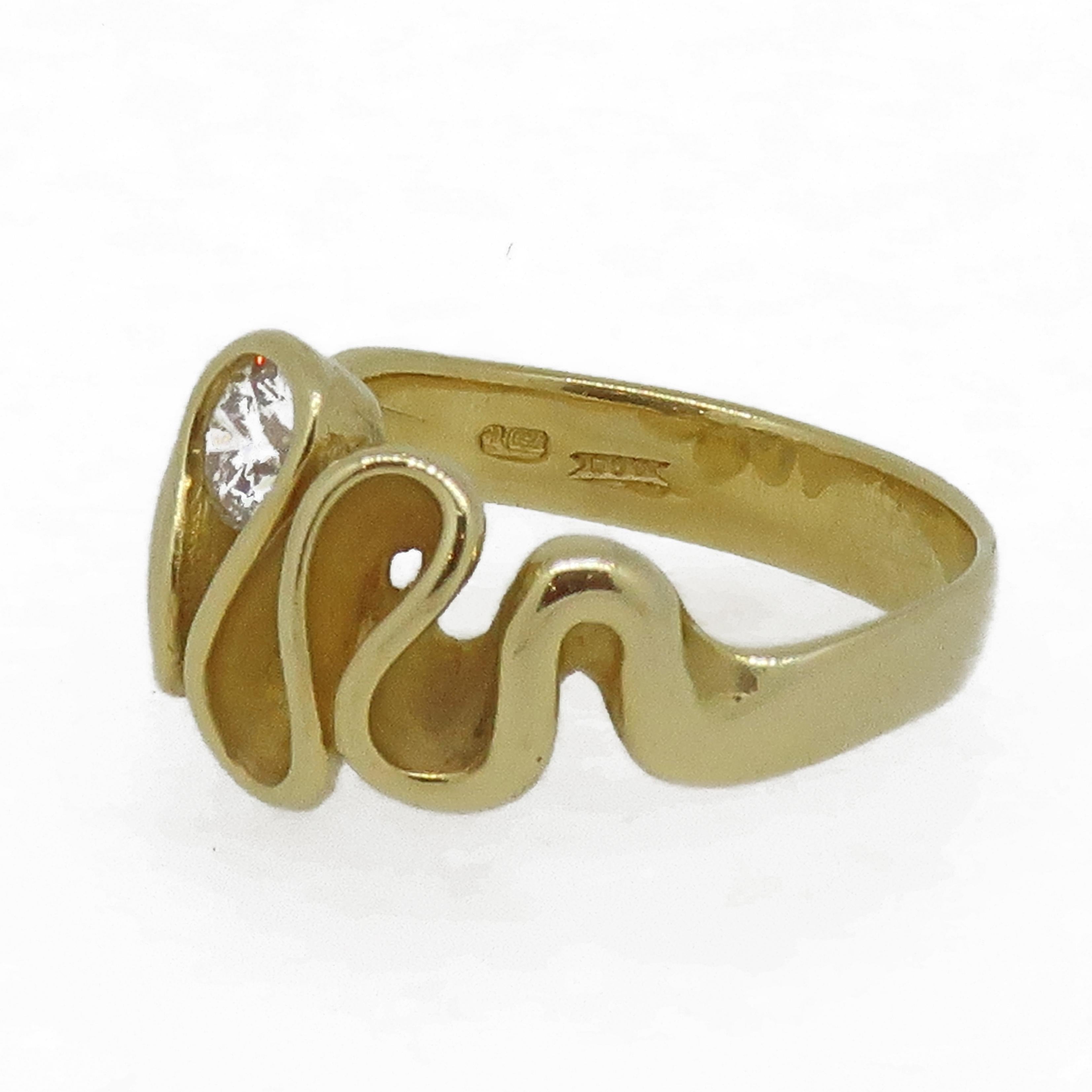 Swirl Diamond Solitaire Ring 18 Karat Yellow Gold

A different and stand out brilliant cut diamond ring. The round brilliant cut diamond is set in a swirl of gold, on a wide 18ct yellow gold shank. This is a very unusual and striking design and one