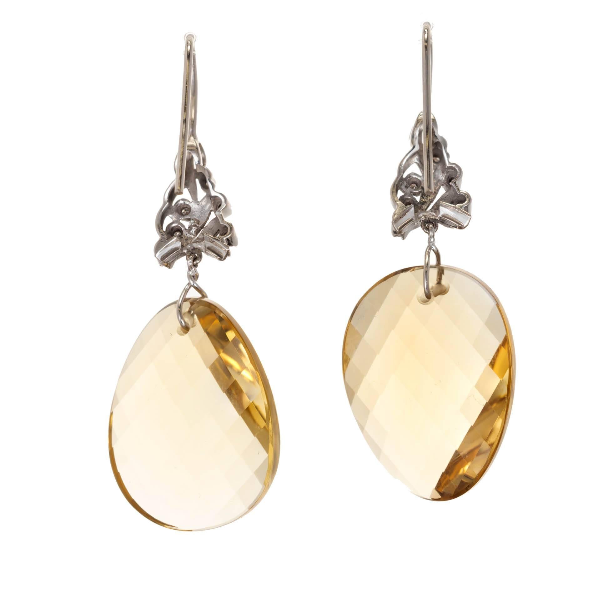 14k white gold wire top diamond dangle earrings with swirl faceted free form natural untreated 43.00ct lemon quartz dangles.

2 yellow citrine oval 25.19 x 18.22 golden yellow all natural 43.00ct total
12 round Diamond H, SI Approx.  .15ct