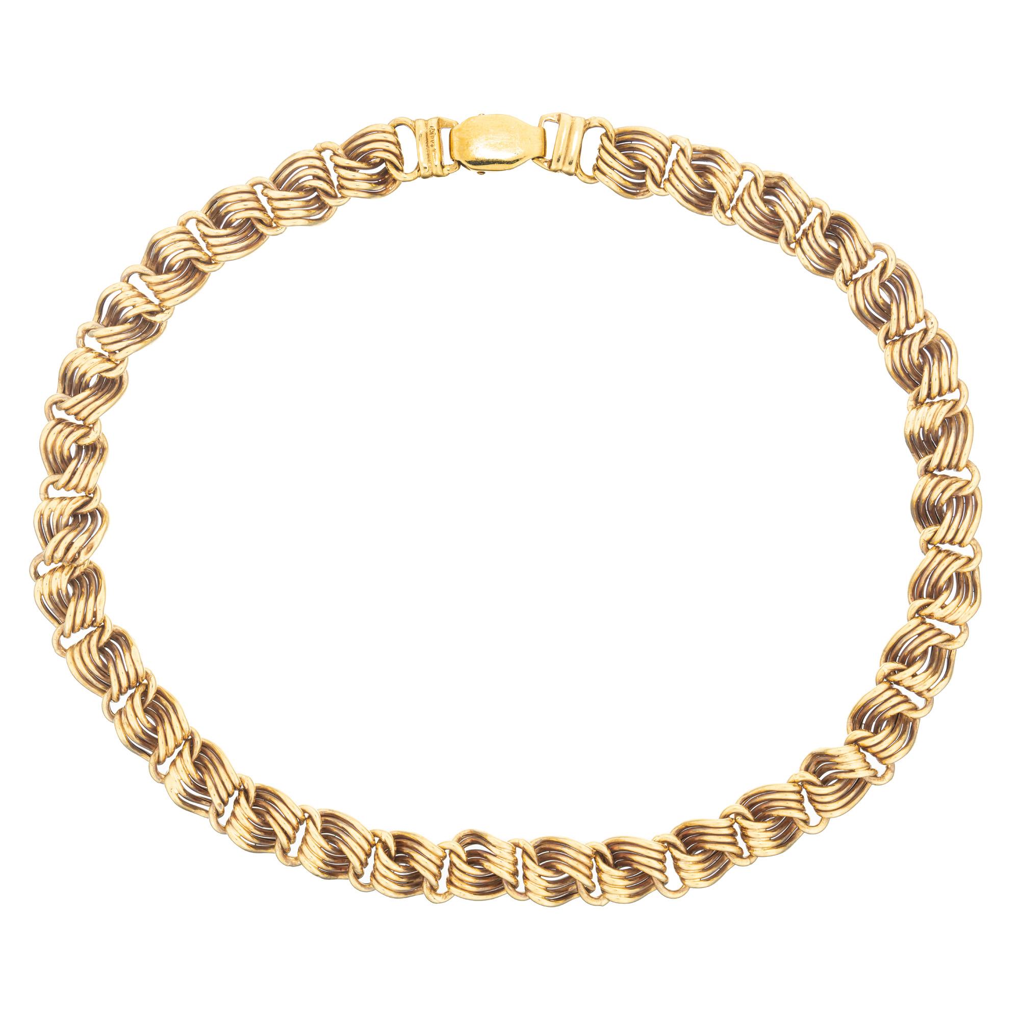 Vintage 1970's, Swirl Link Four Row 18k Yellow Gold Necklace, a truly magnificent piece that exudes elegance. Made from 18k yellow gold, this necklace is made from groups of four intricate swirl links. Measuring at 16.5 inches in length.  The secure